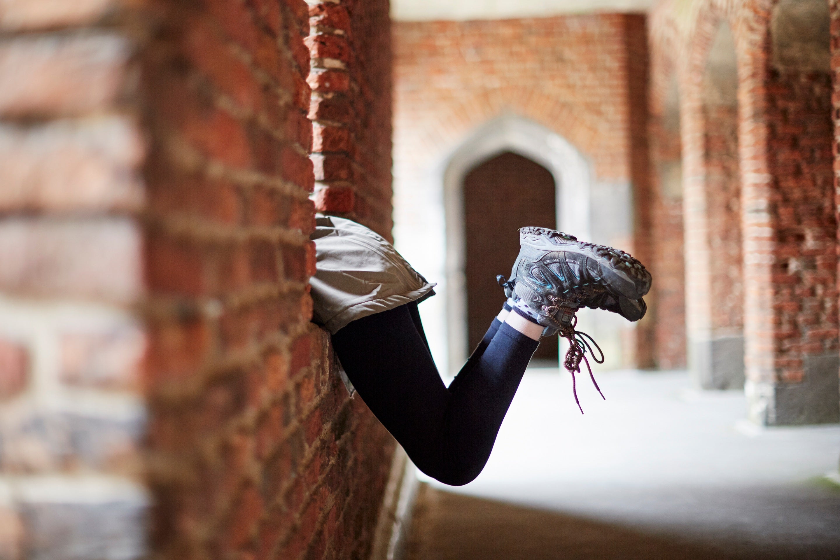 Children's feet sticking out from a window in the medieval tower at Tattershall Castle, Lincolnshire