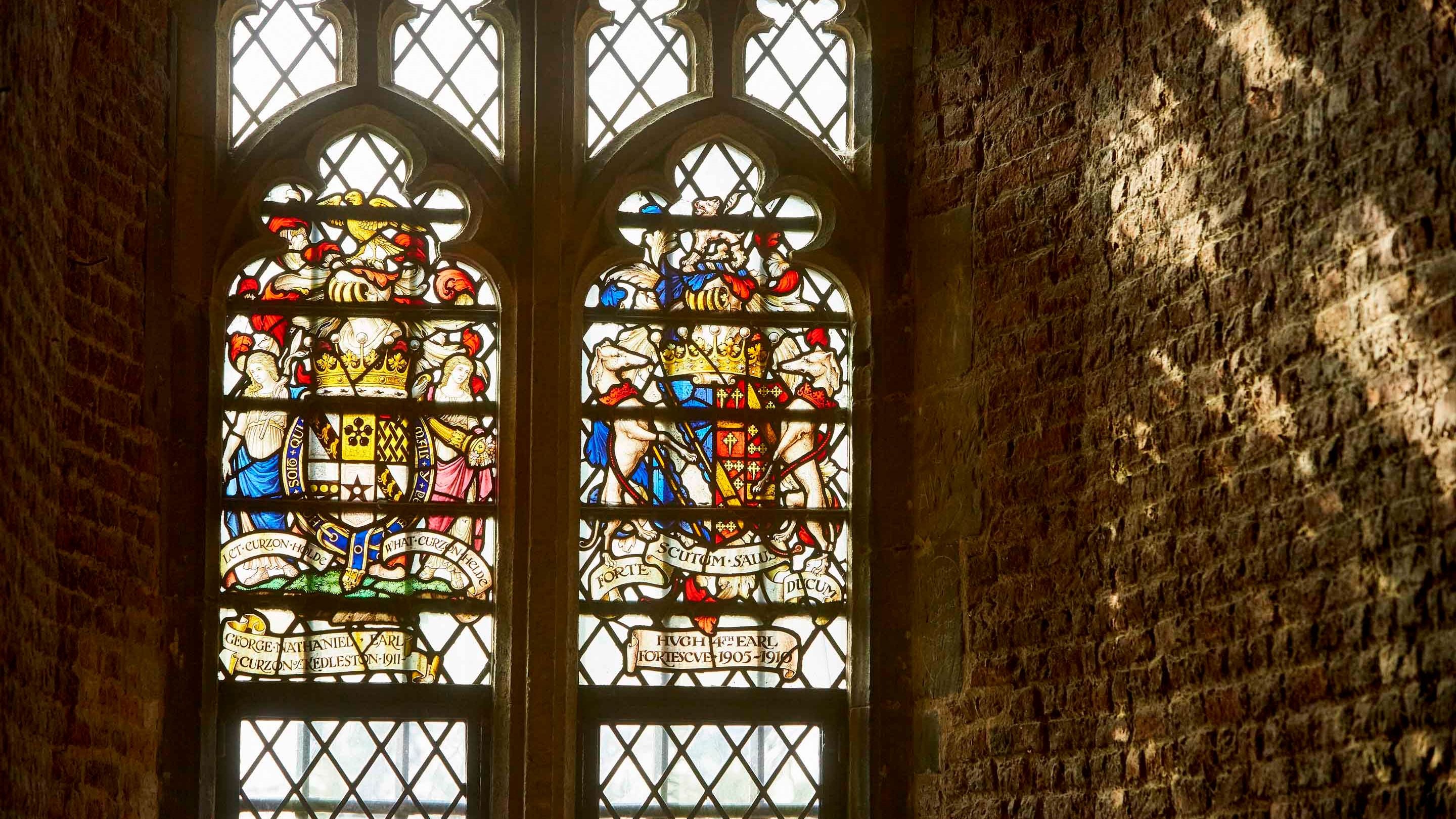 Sunlight illuminating a heraldic stained glass window at Tattershall Castle, Lincolnshire