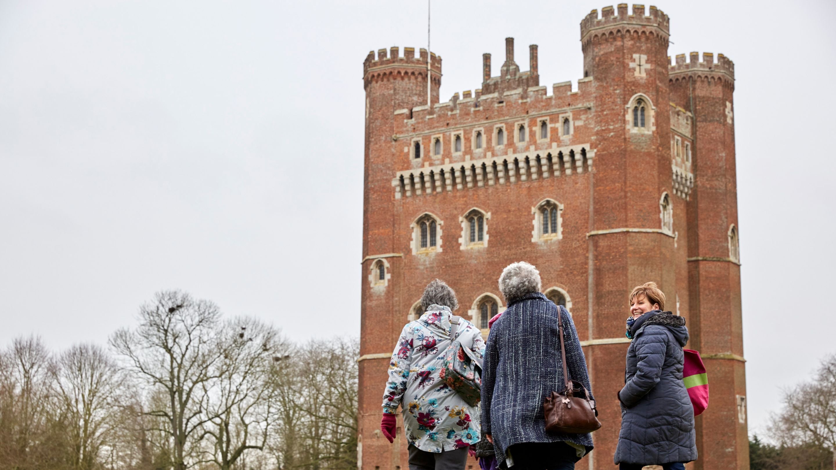 Three female visitors outside the east front of Tattershall Castle, Lincolnshire