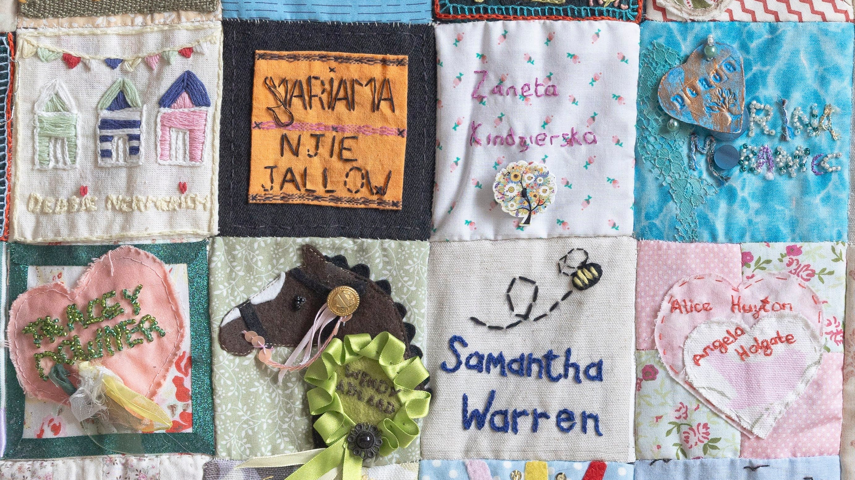 Squares of a patchwork quilt with names on