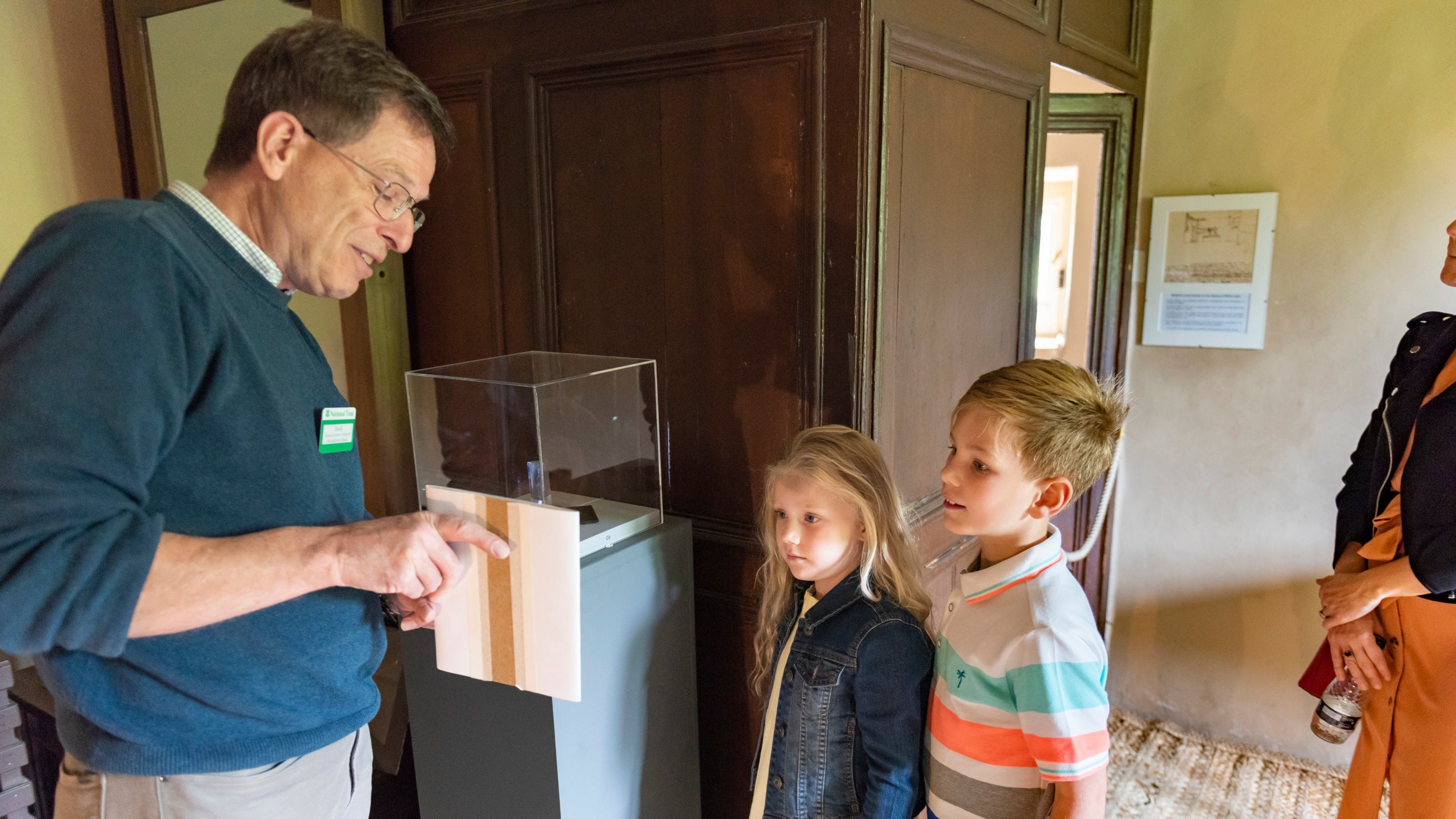 A volunteer talks to some younger visitors in Woolsthorpe Manor, Lincolnshire