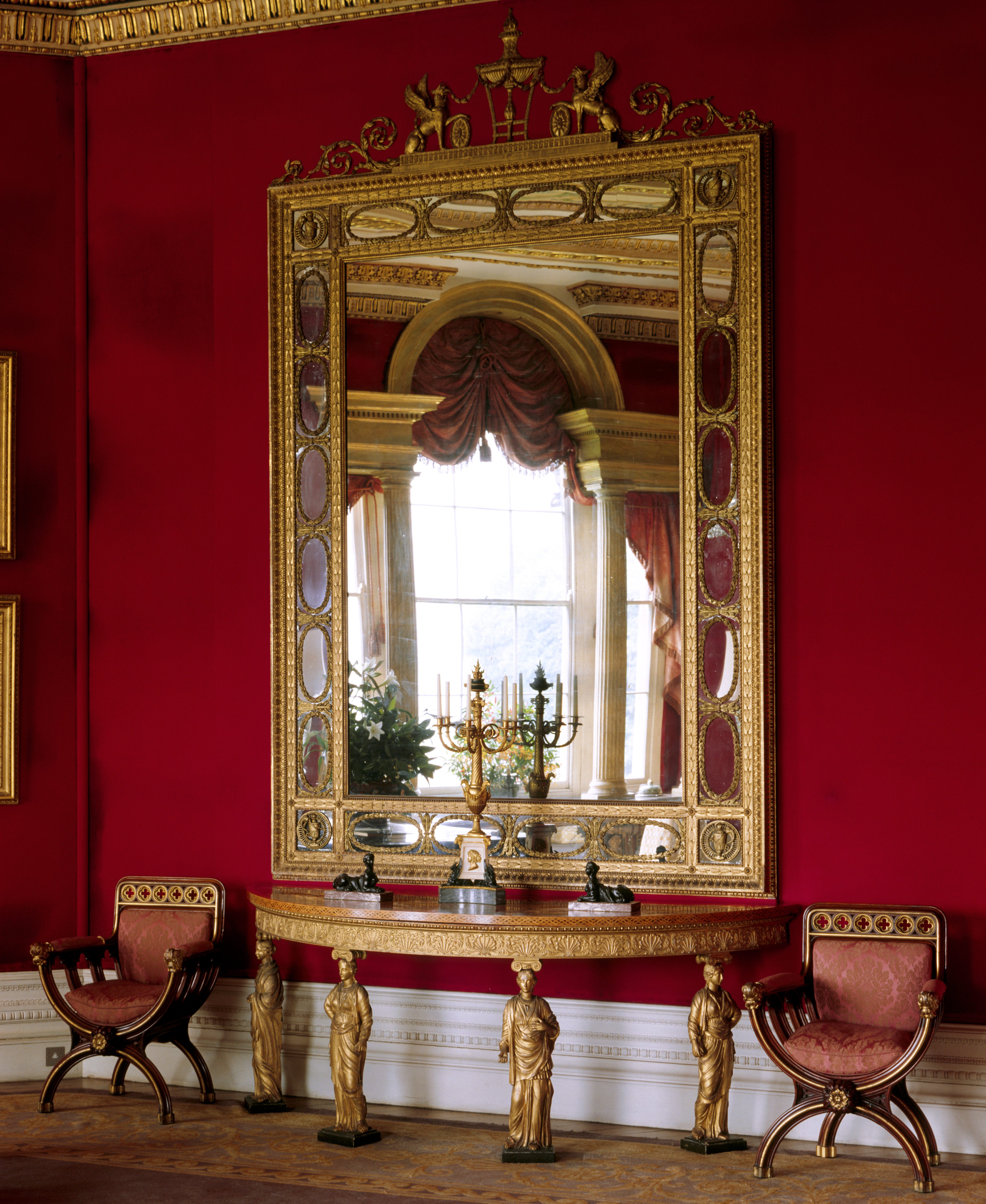 The Octagon Drawing Room, Basildon. View of a Neo-classical gilt pier-glass and table. The pier-table is supported by female figures inspired by the Erechtheum on the Acropolis at Athens.