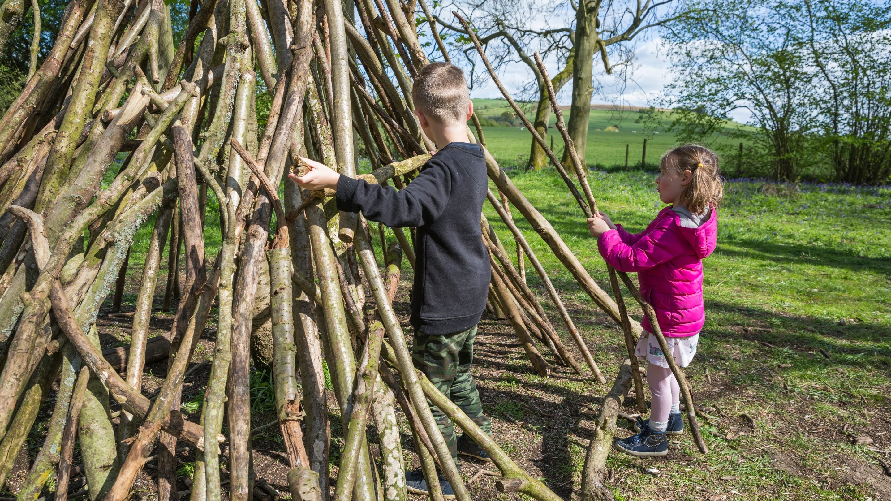 Children building a den at Boarstall Duck Decoy, Buckinghamshire