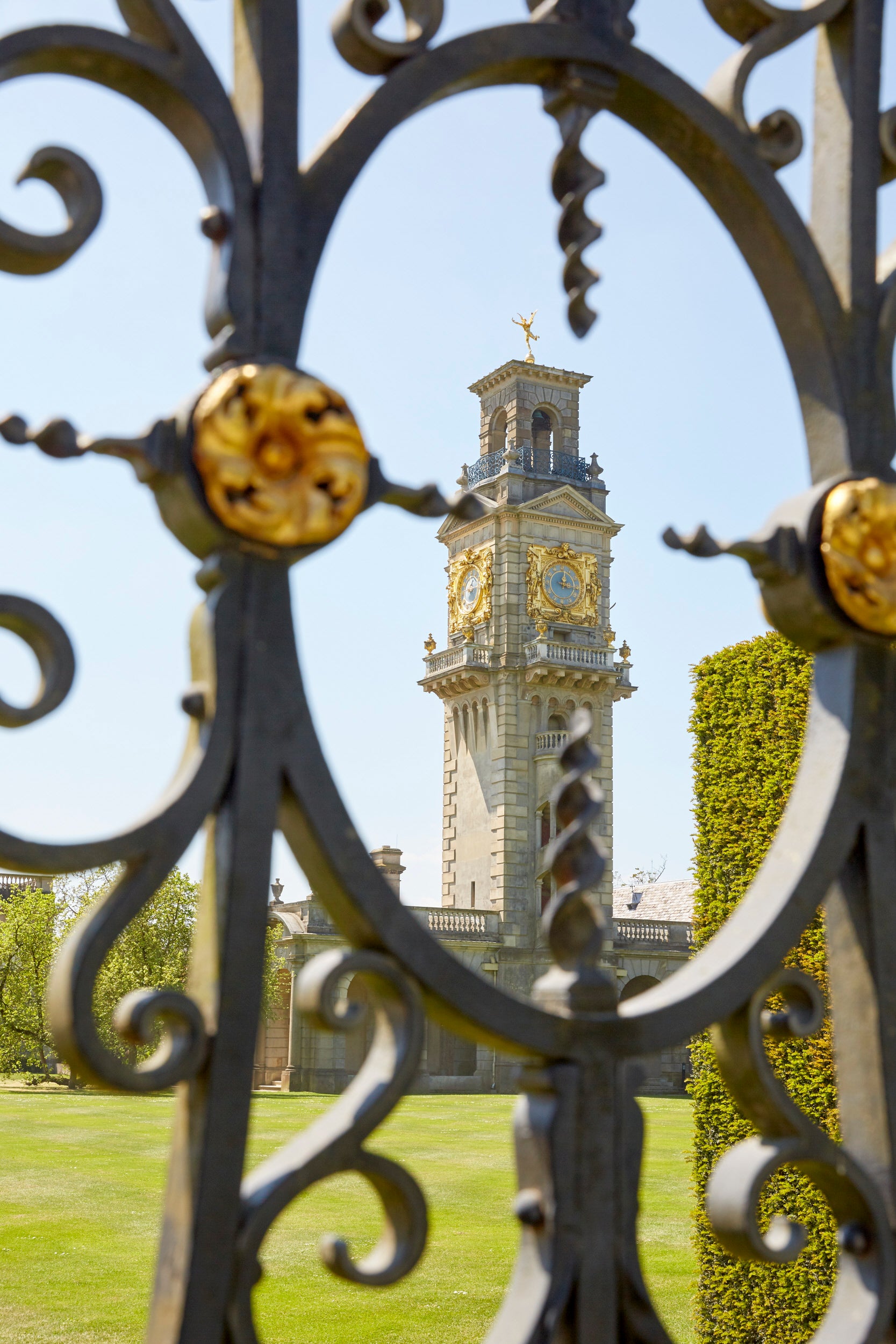View of the Italianate clock tower through ornate gates at Cliveden, Buckinghamshire