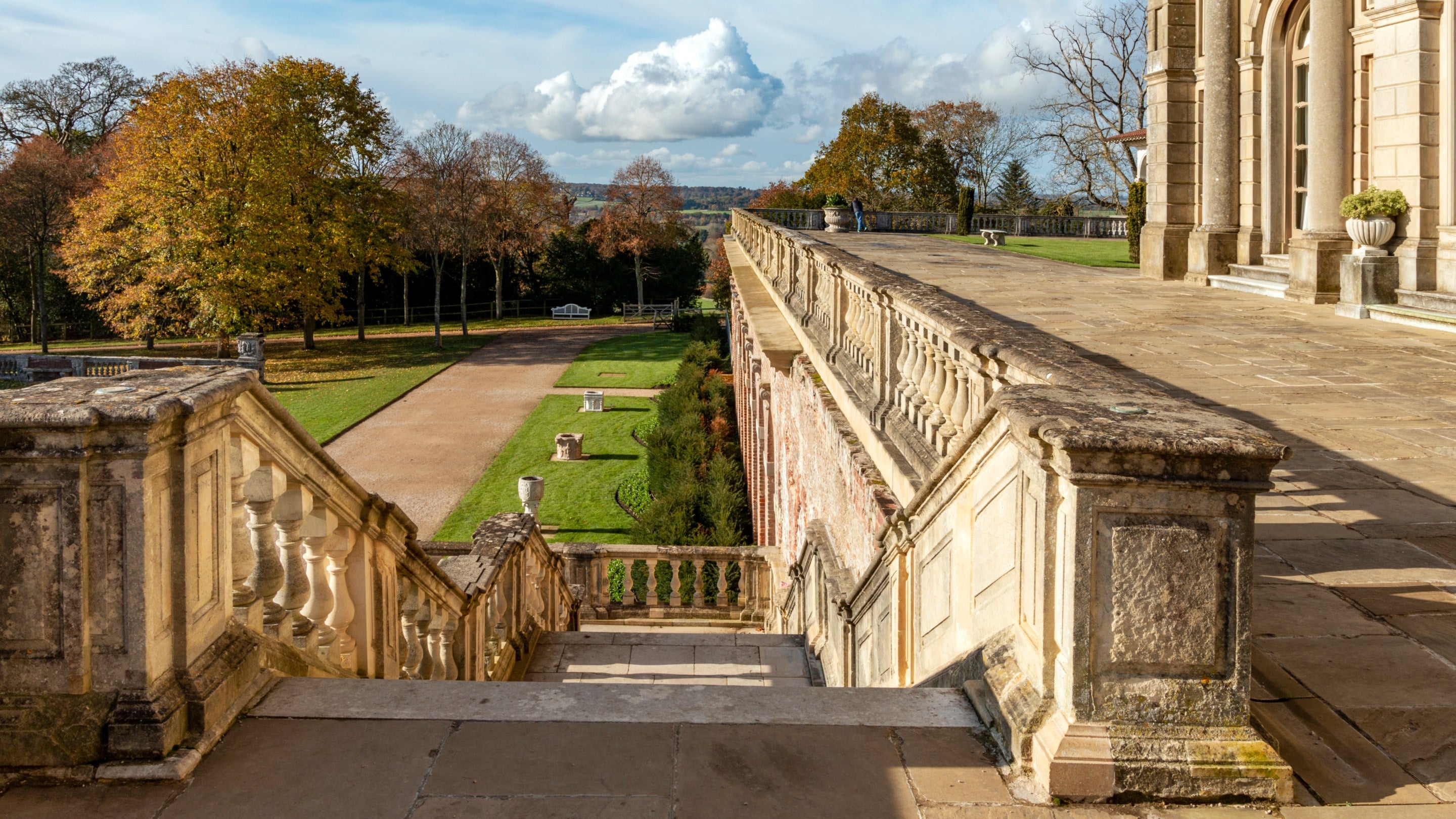 A view down the pale cream stone south terrace steps onto the parterre at Cliveden in Buckinghamshire