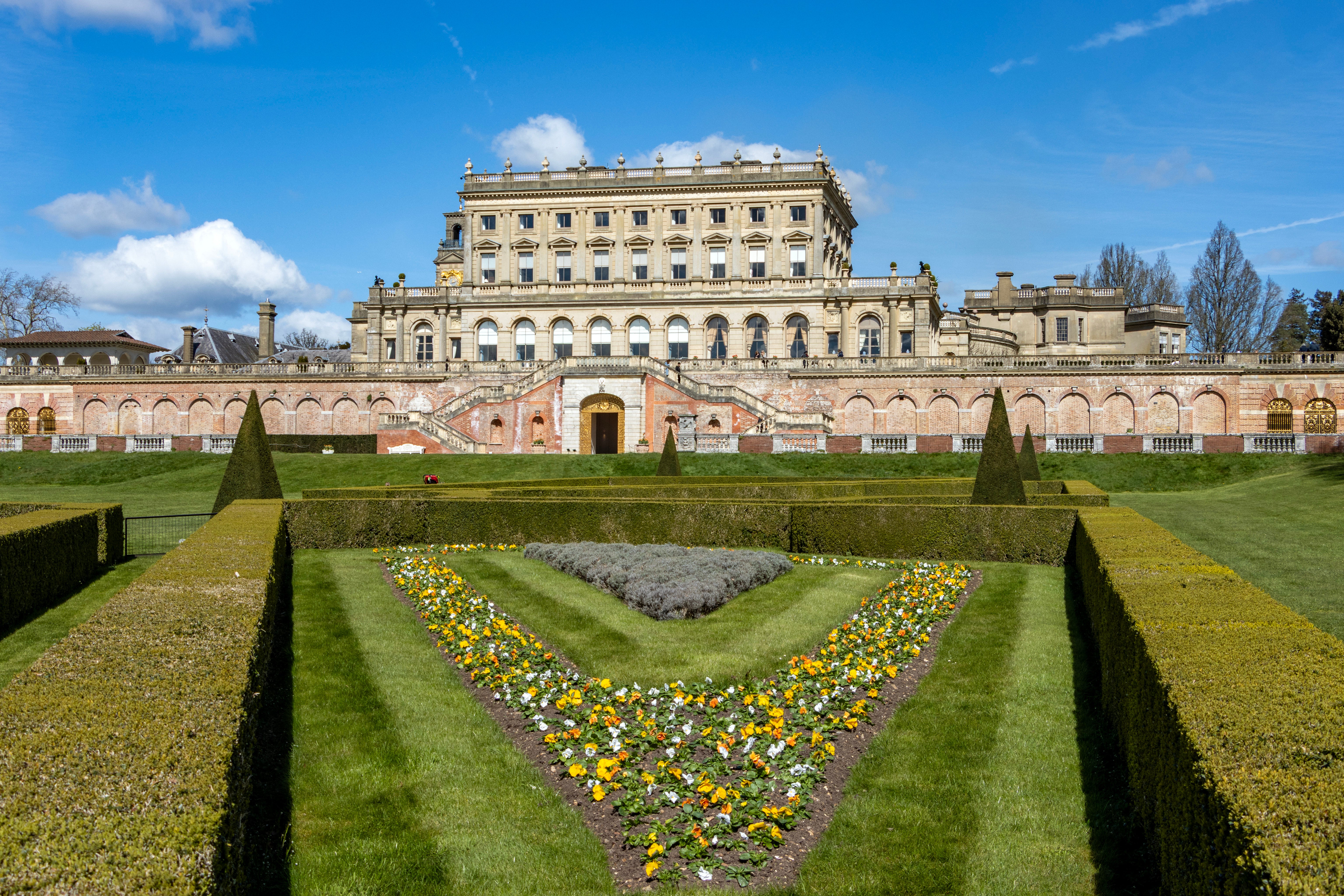 Orange, white and yellow flowers in the flower bed on the parterre at Cliveden, Buckinghamshire.