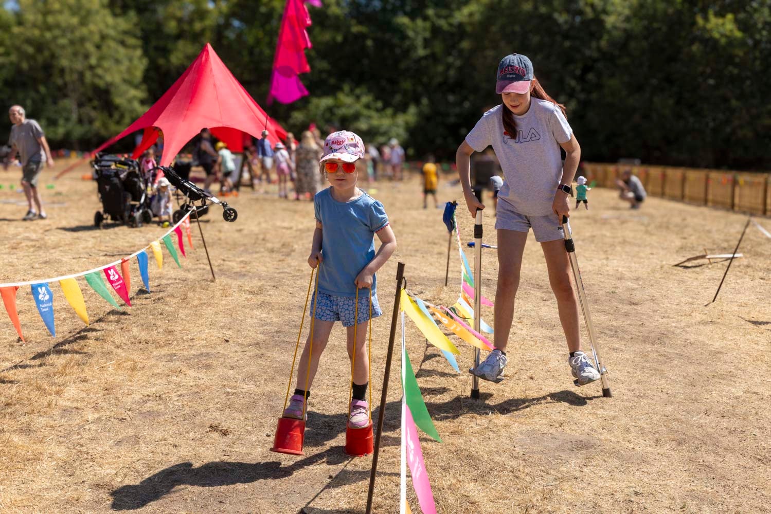 Visitors on stilts as part of Summer of Play at Cliveden
