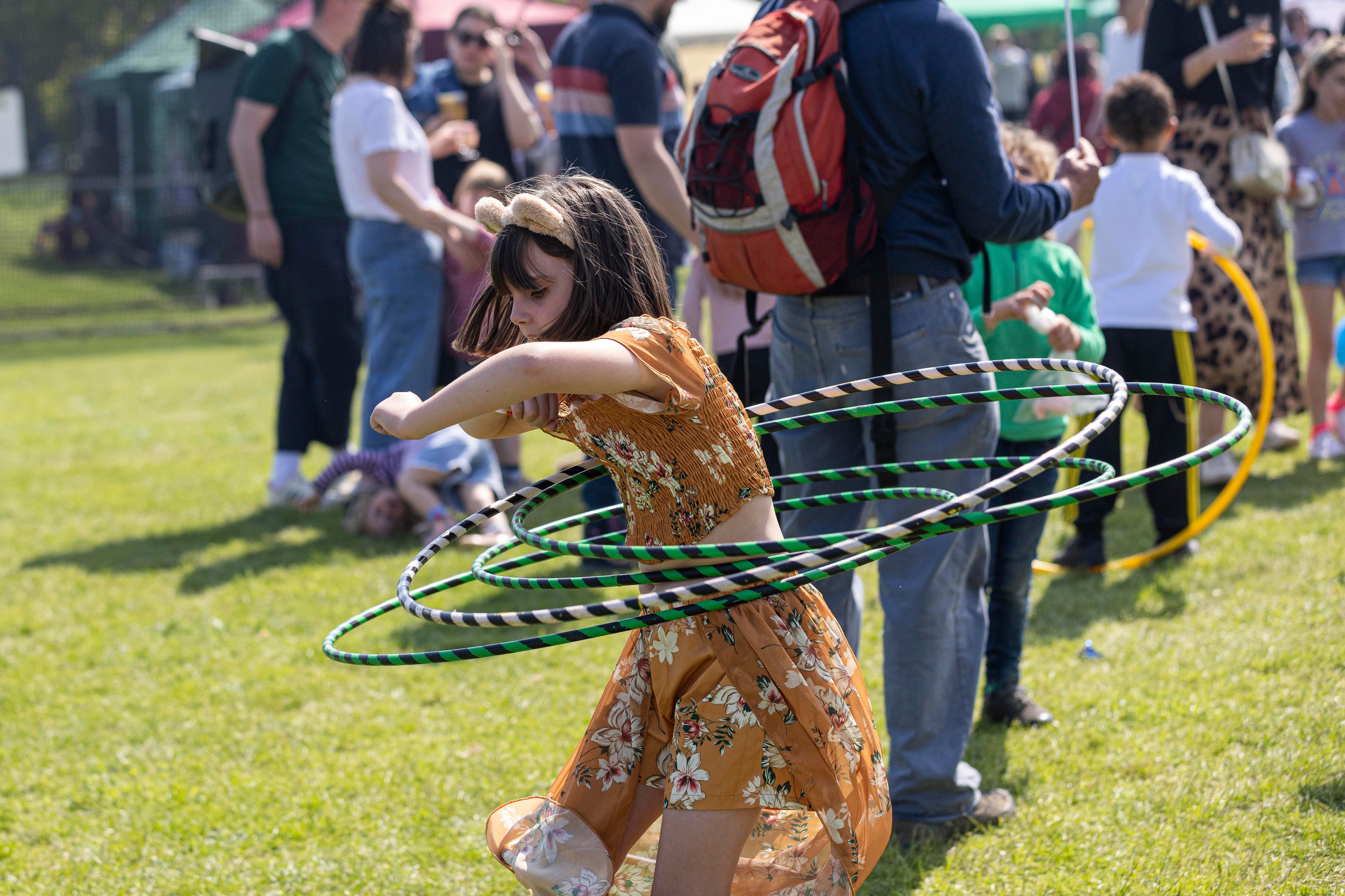 A girl doing hula hoops, taking part in a circus workshop