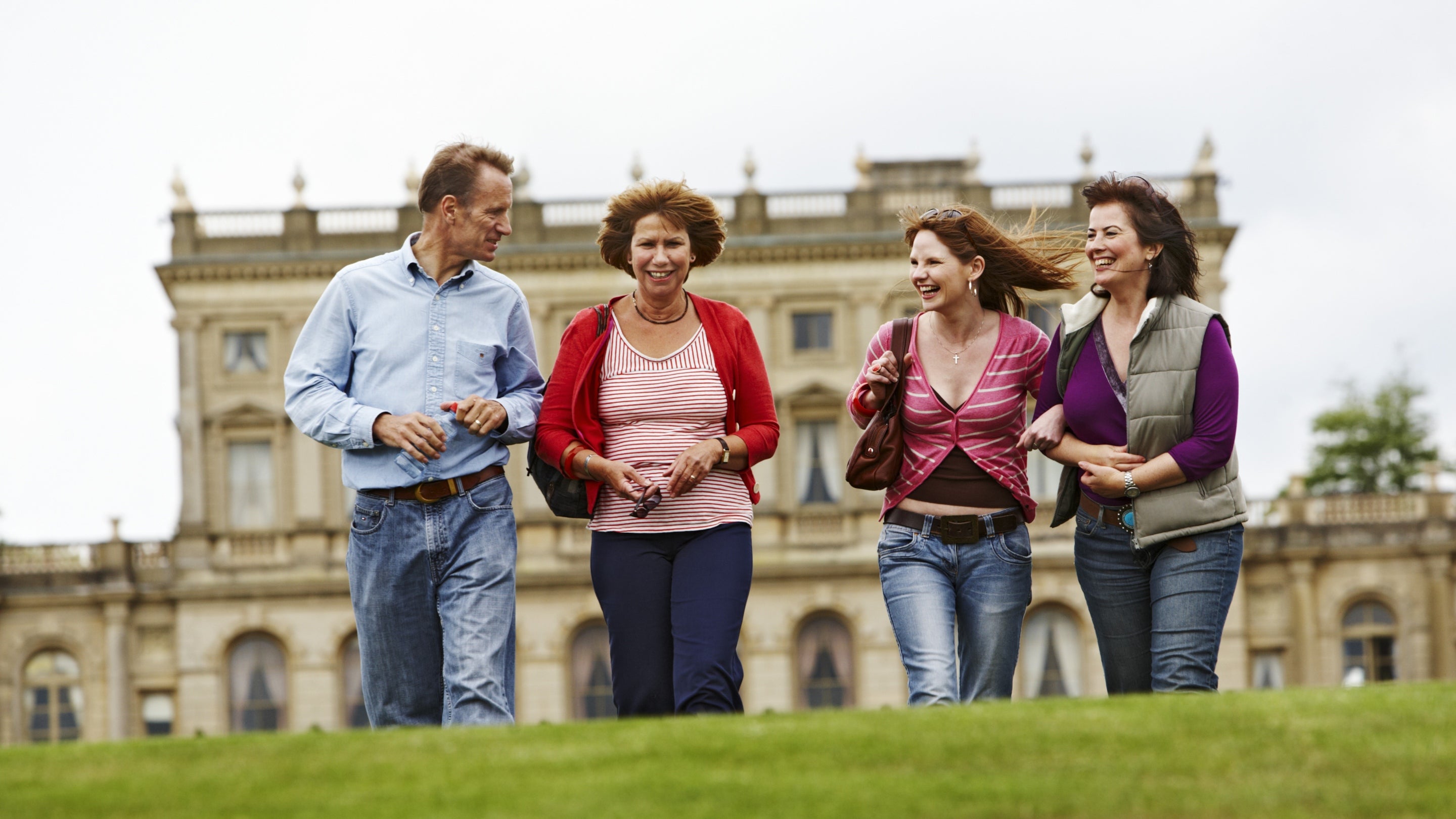 Visitors in the Parterre garden with the house in the background at Cliveden, Buckinghamshire