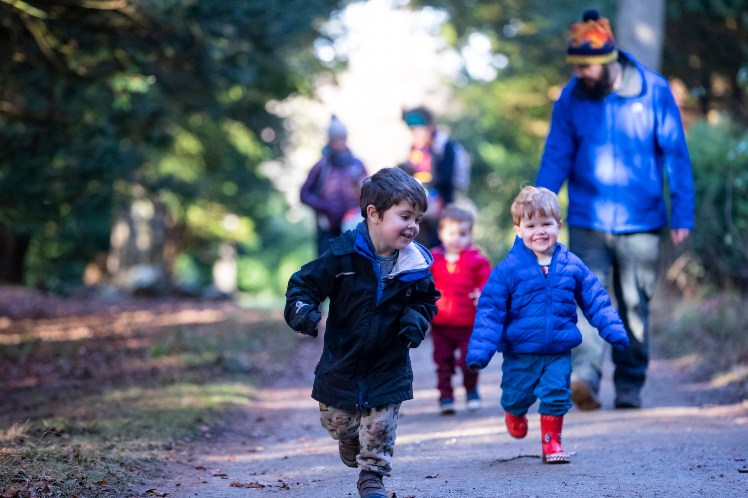 view of a young family walking in woods