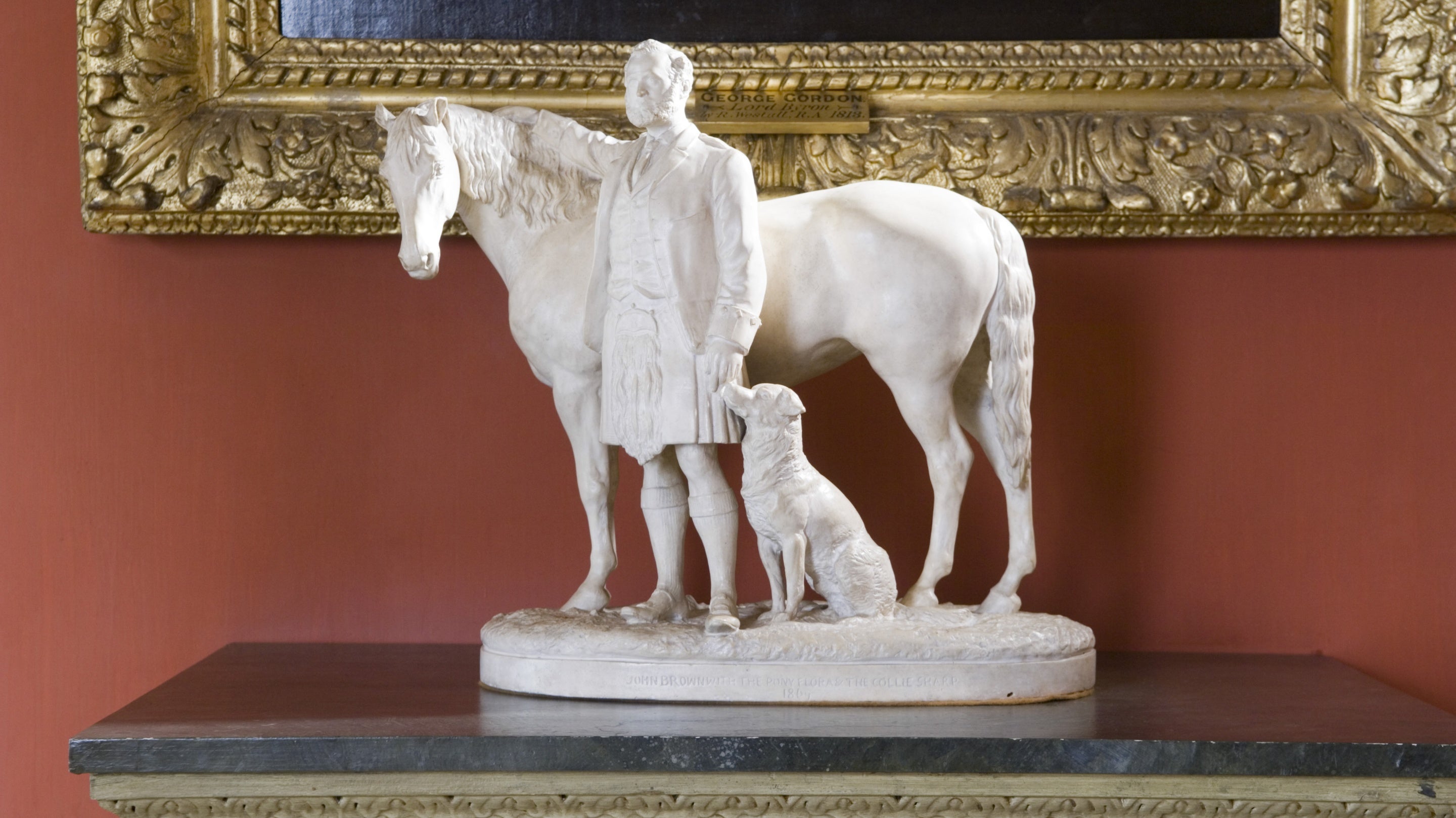 The statuette John Brown with the Queens's pony Flora and border collie sharp, after Sir Edwin Landseer, RA (1802-1873) in the Entrance Hall at Hughenden Manor, Buckinghamshire