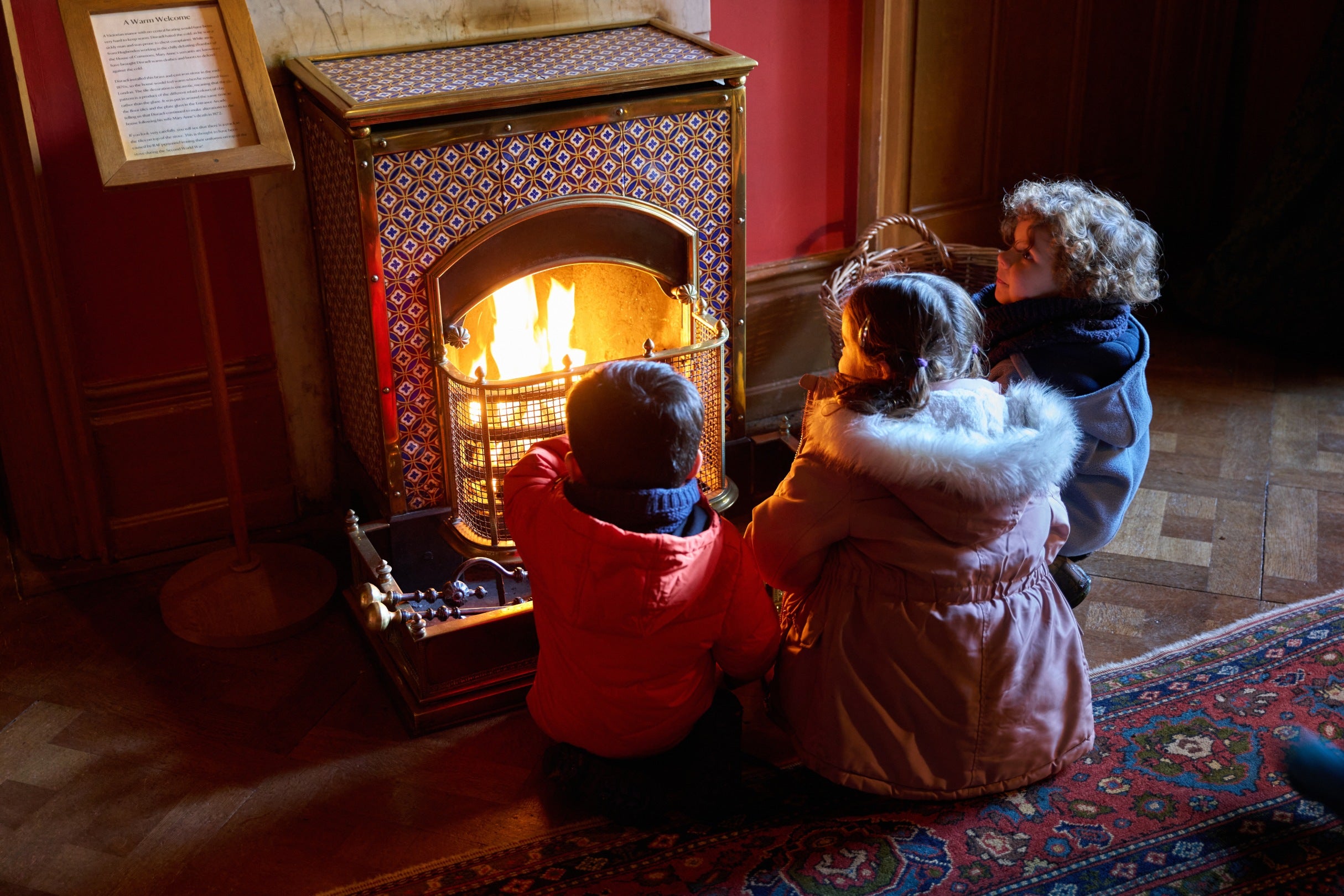 Children gathered around the fire at Hughenden Manor