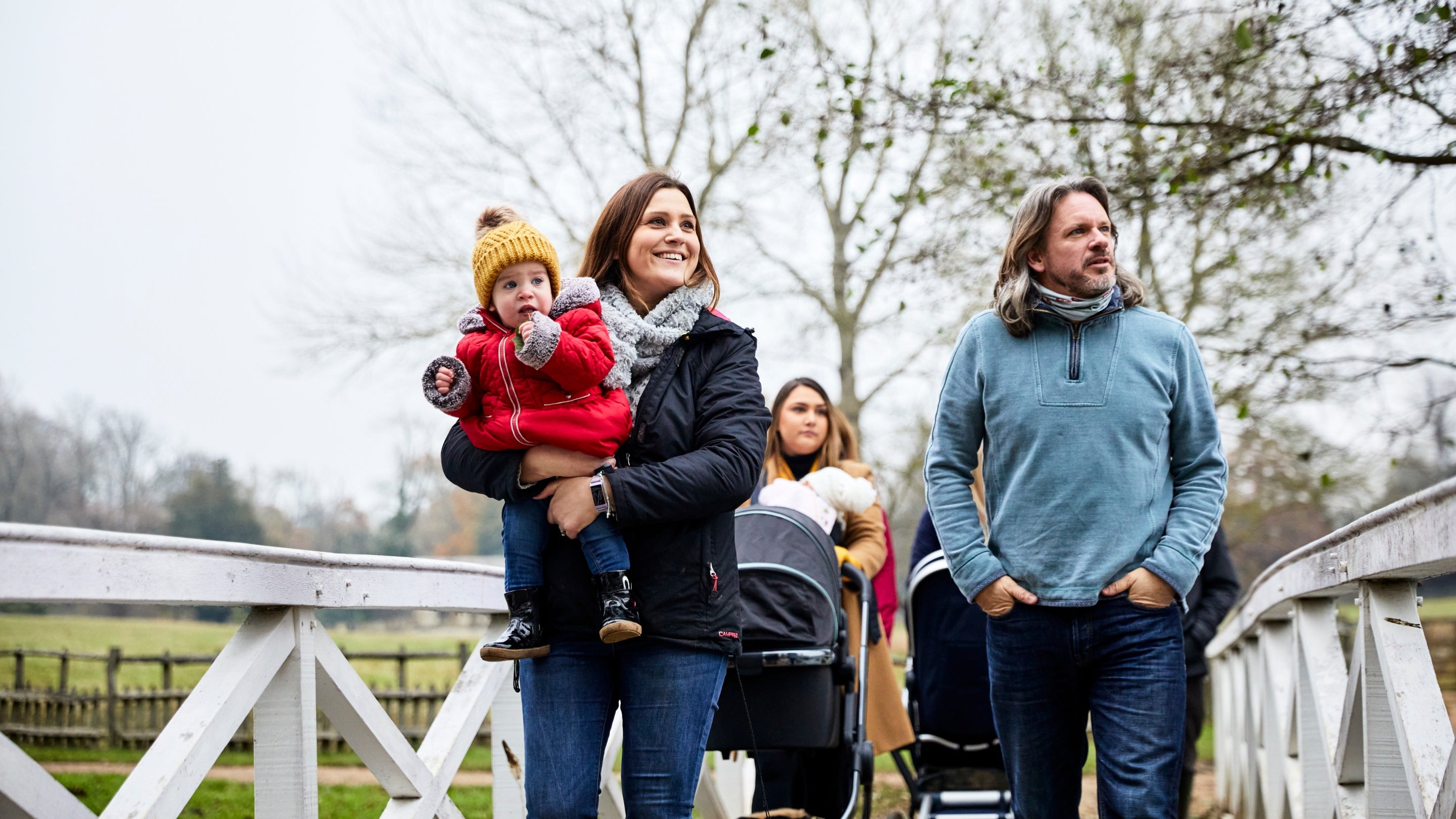 Visitors enjoying an autumnal walk in the landscaped garden at Stowe, Buckinghamshire