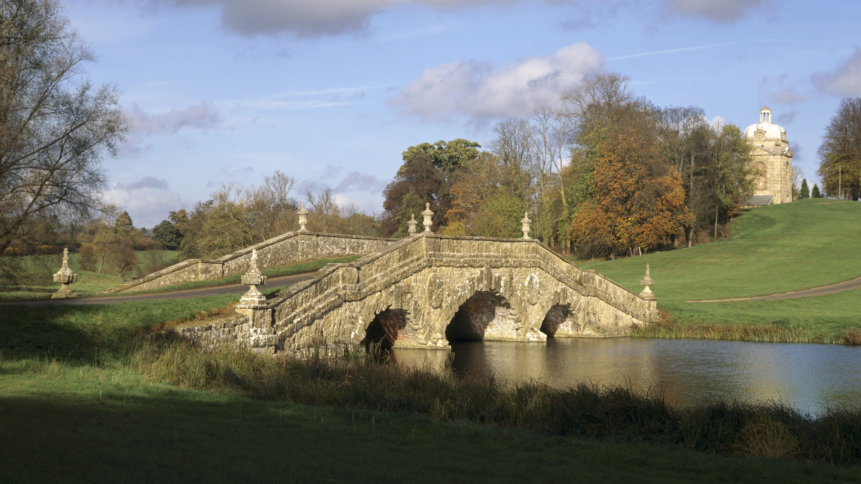 The Oxford Bridge and Water at Stowe Landscape Gardens, Buckinghamshire, with one of the Boycott Pavilions on the horizon.