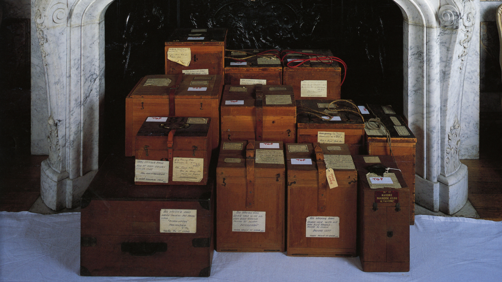 Wooden boxes stacked in white marble fireplace