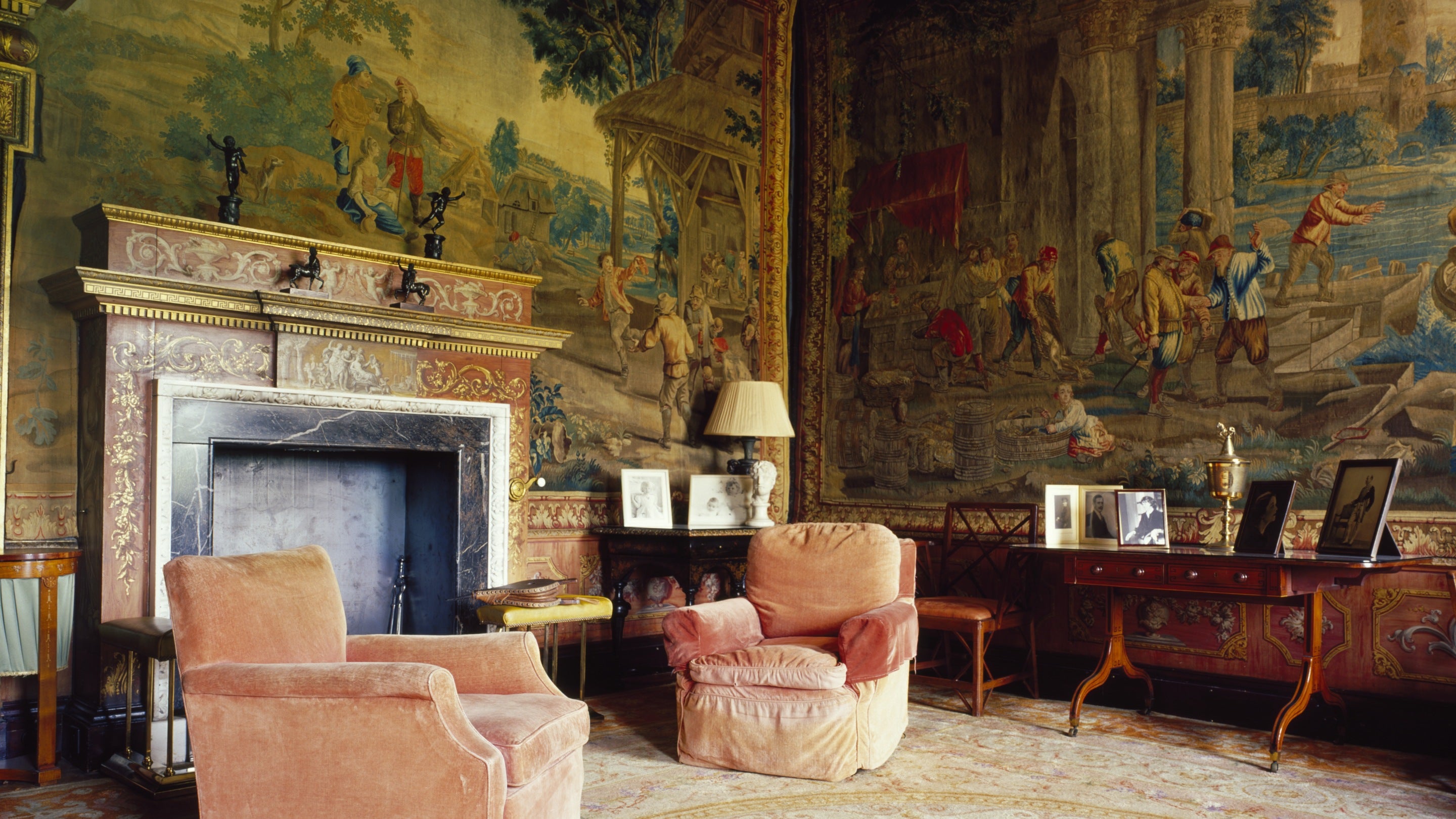 View of the Tapestry Room, showing the ornate chimney-piece and tapestries at West Wycombe Park