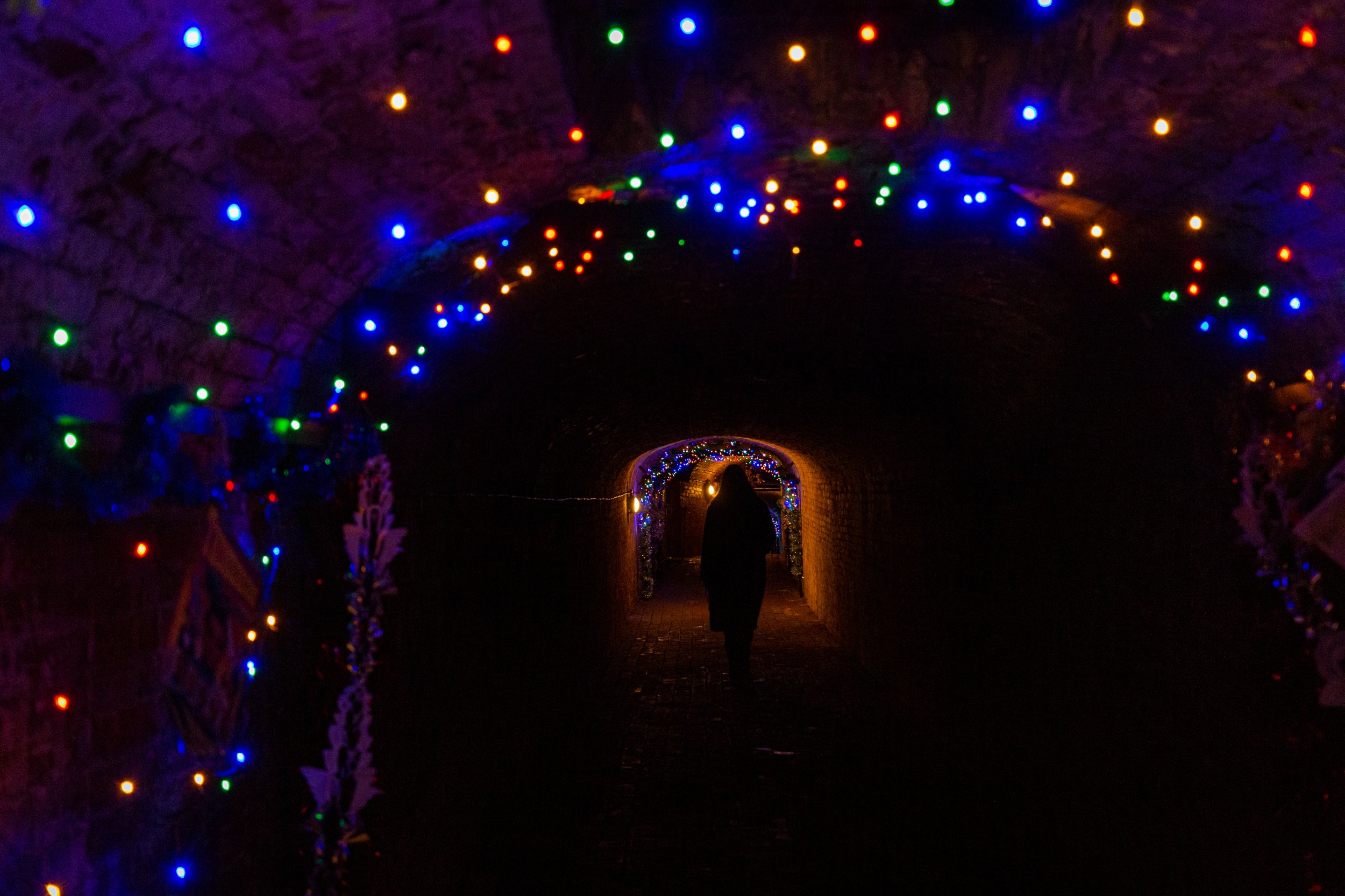 The tunnels at Calke Abbey, with multicoloured lights strung across the ceilings and down the walls.