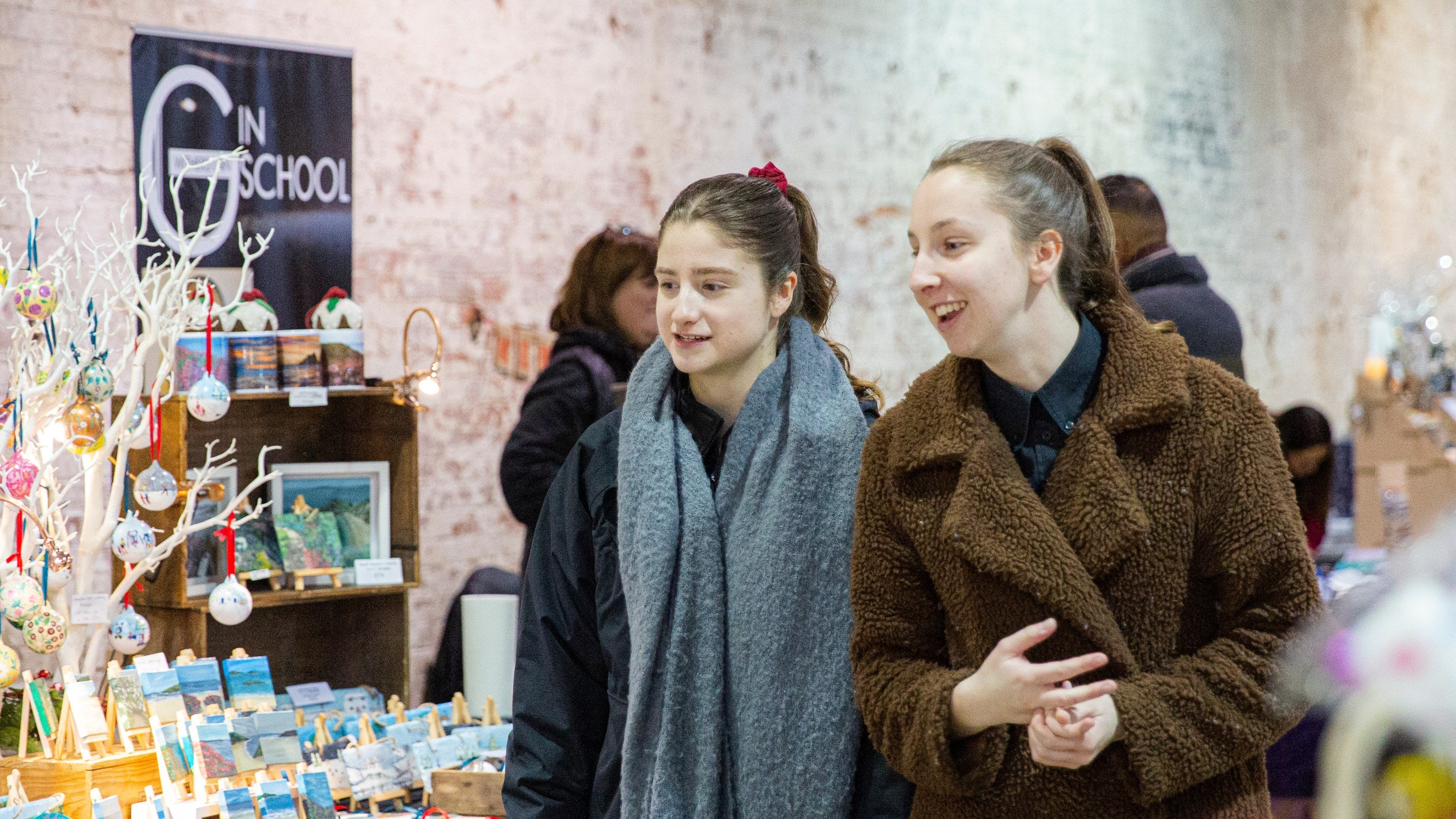 Image shows two visitor exploring the indoor Christmas market