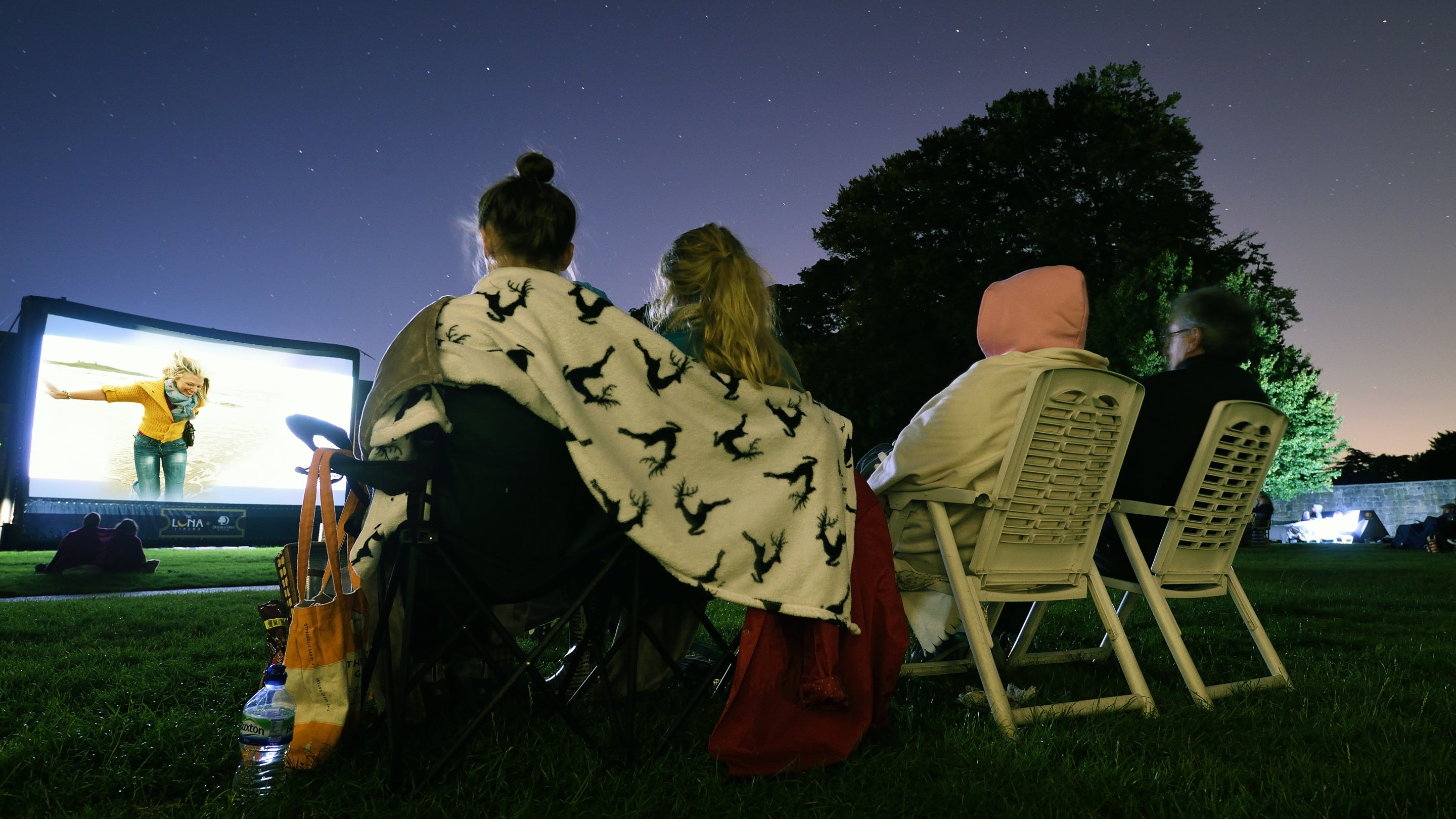 Visitors at an open-air cinema event on the grounds at Hardwick, Derbyshire.