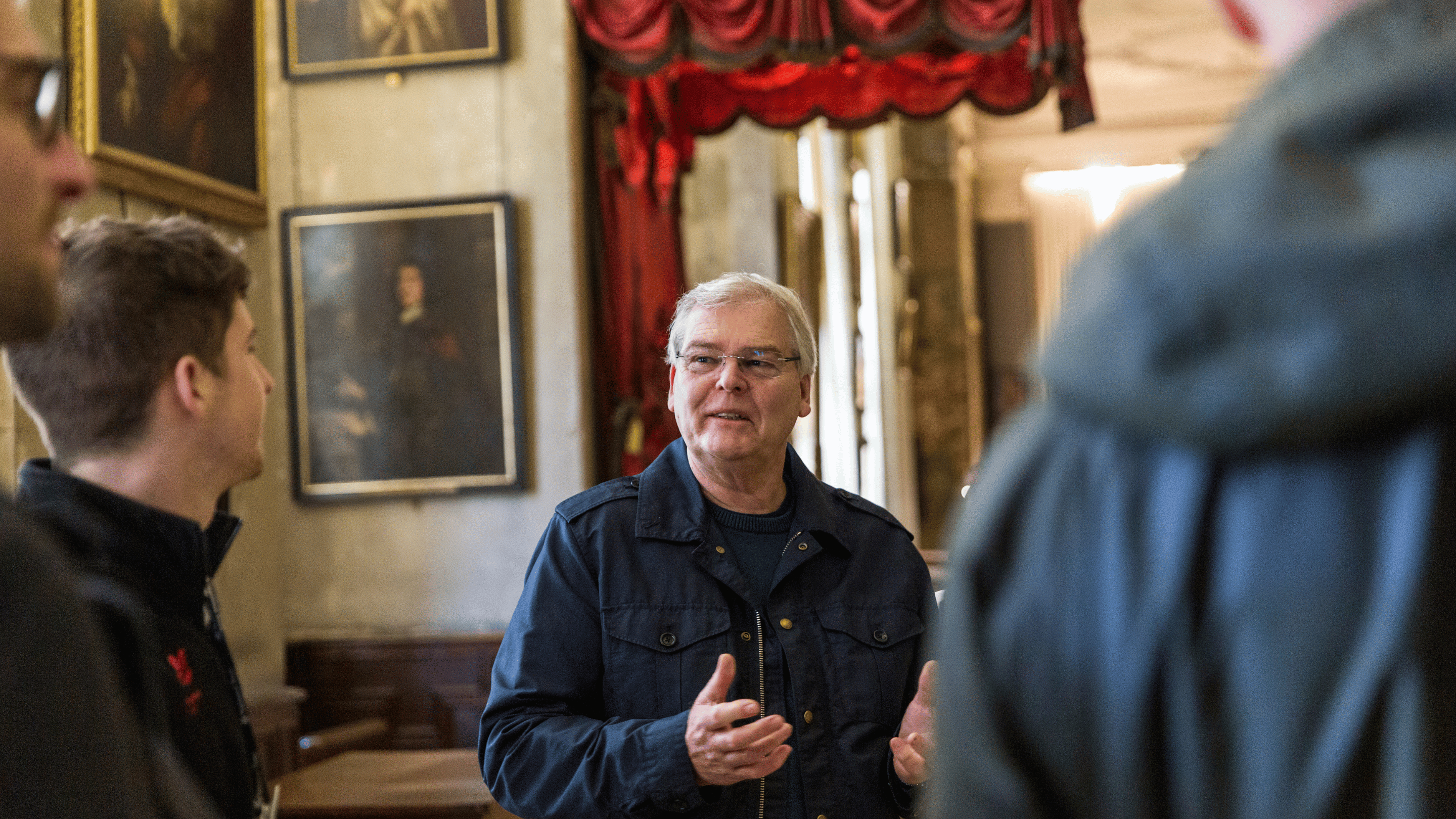 Visitors enjoying a group tour of Hardwick Hall in the Long Gallery.