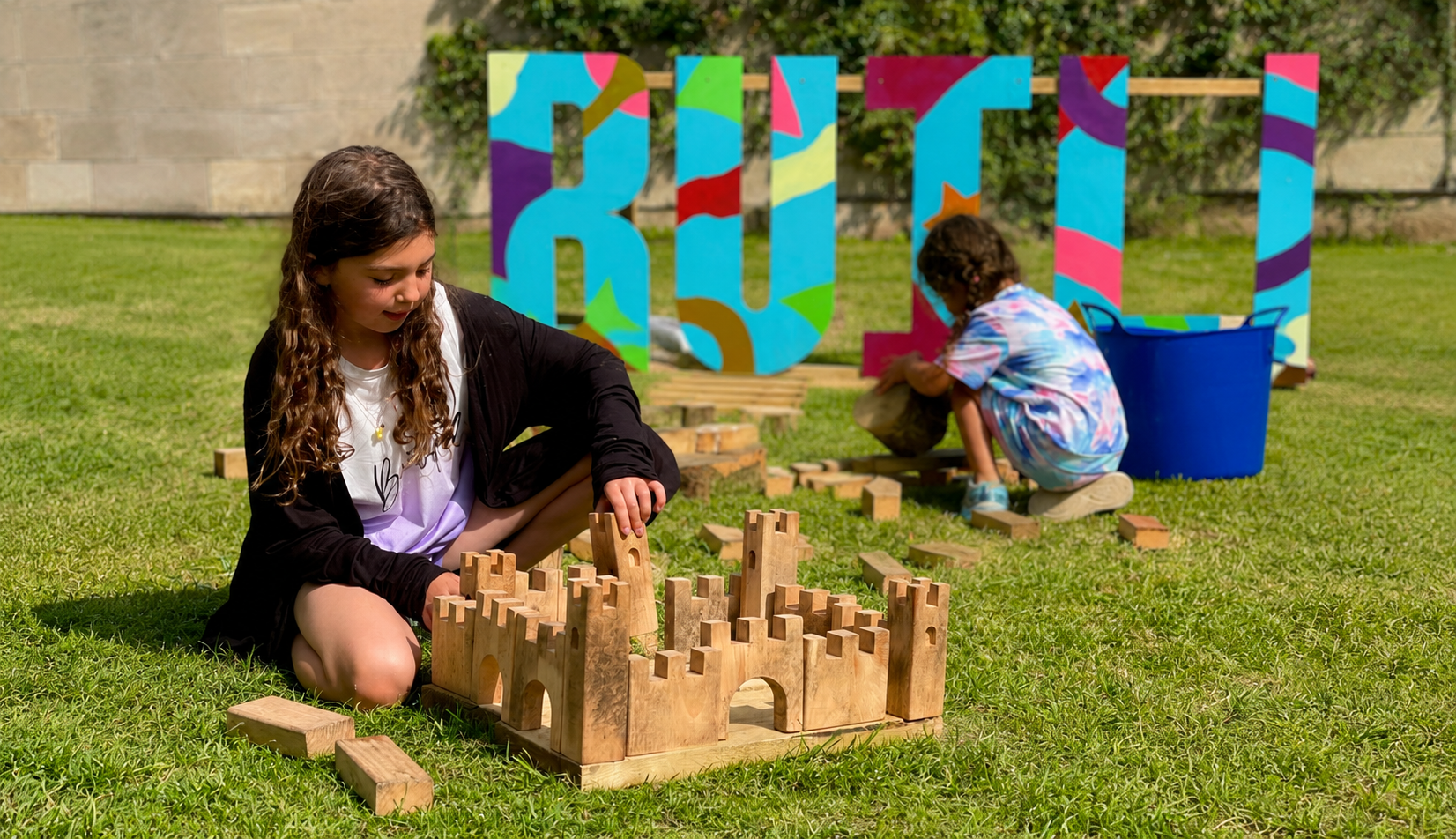 Child playing with building block summer of play Ilam park
