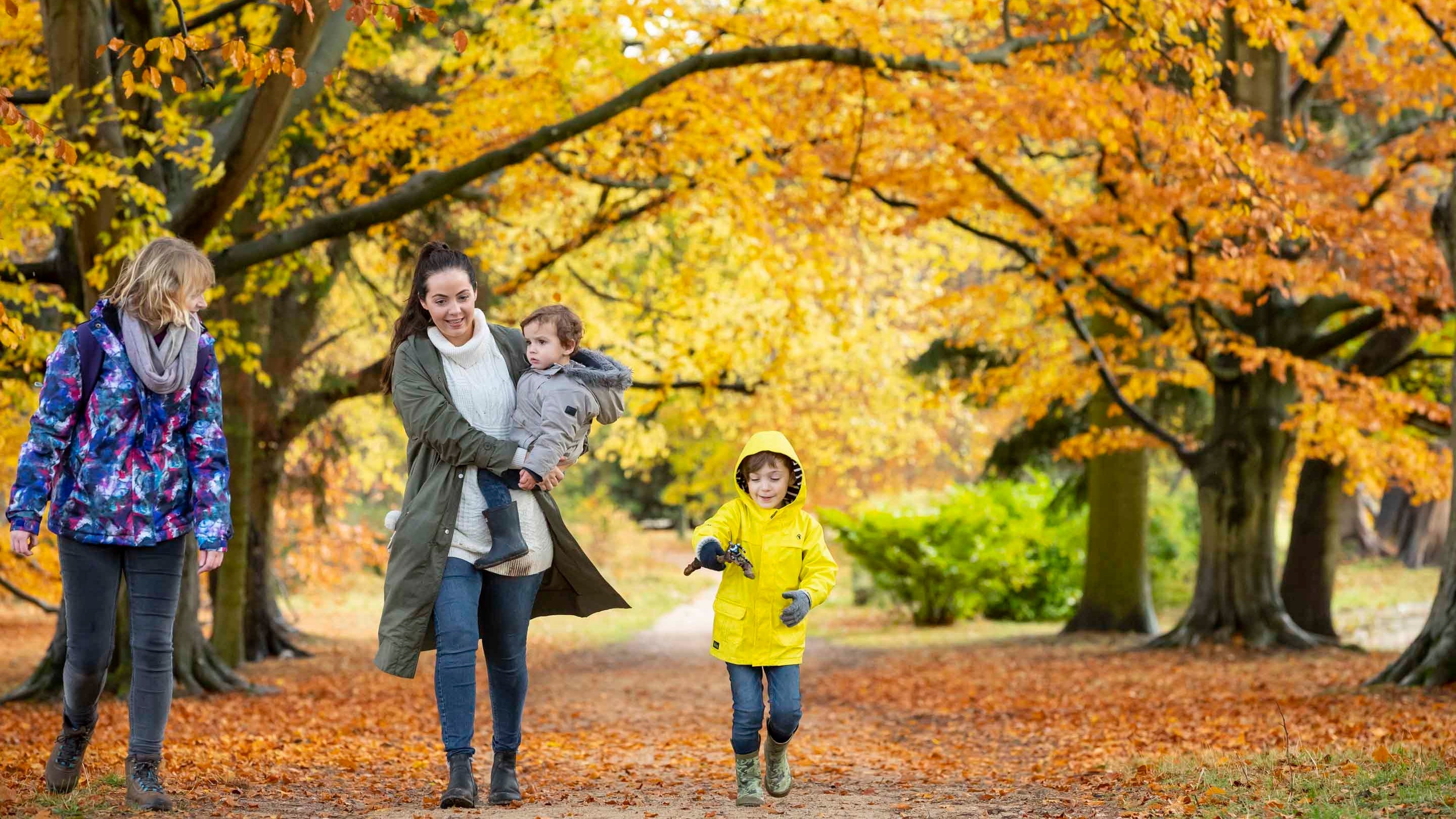 Visitors in the garden in autumn at Kedleston Hall, Derbyshire