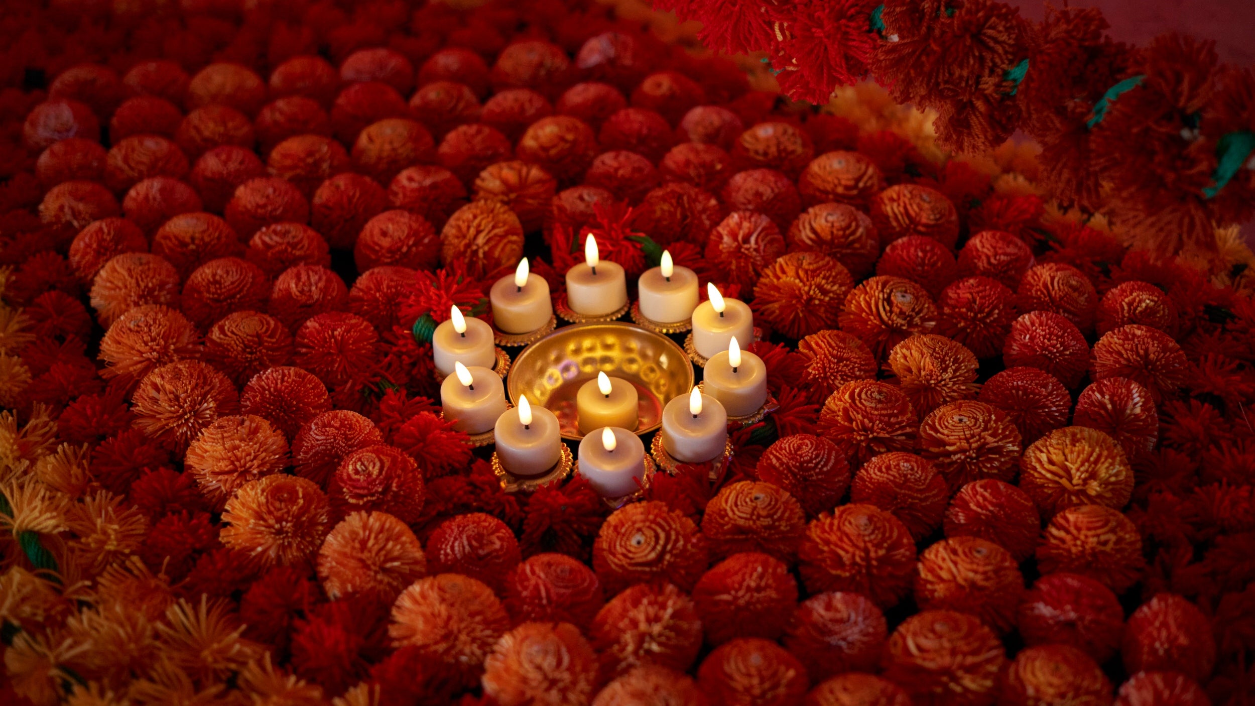 Yellow, red and orange shola pith (indian cork) displayed in rangoli artwork
