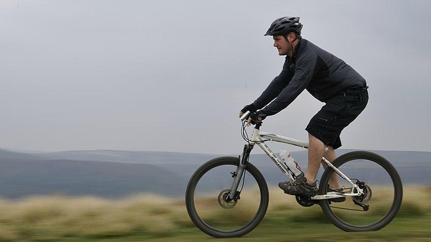 Male mountain biker in black, background blurred