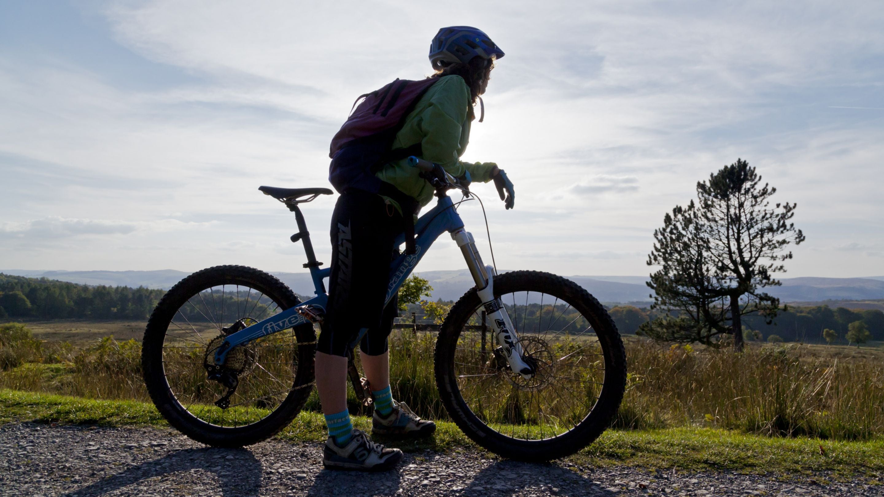 A silhouette of a cyclist against the sky on a trail at Longshaw, Burbage and the Eastern Moors, Derbyshire