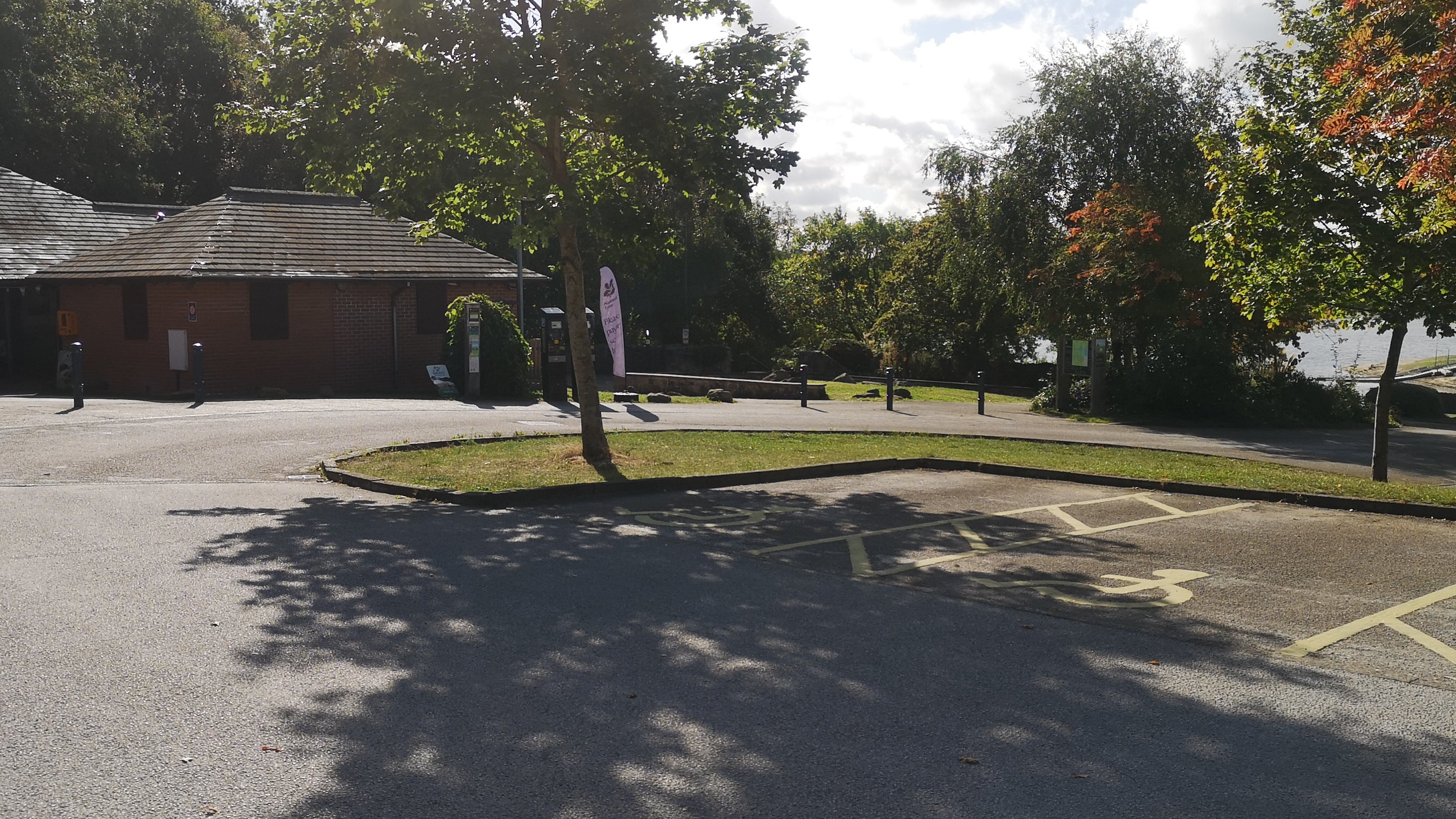 Tarmac car park spaces outside visitor facilities at Staunton Harold, Derbyshire