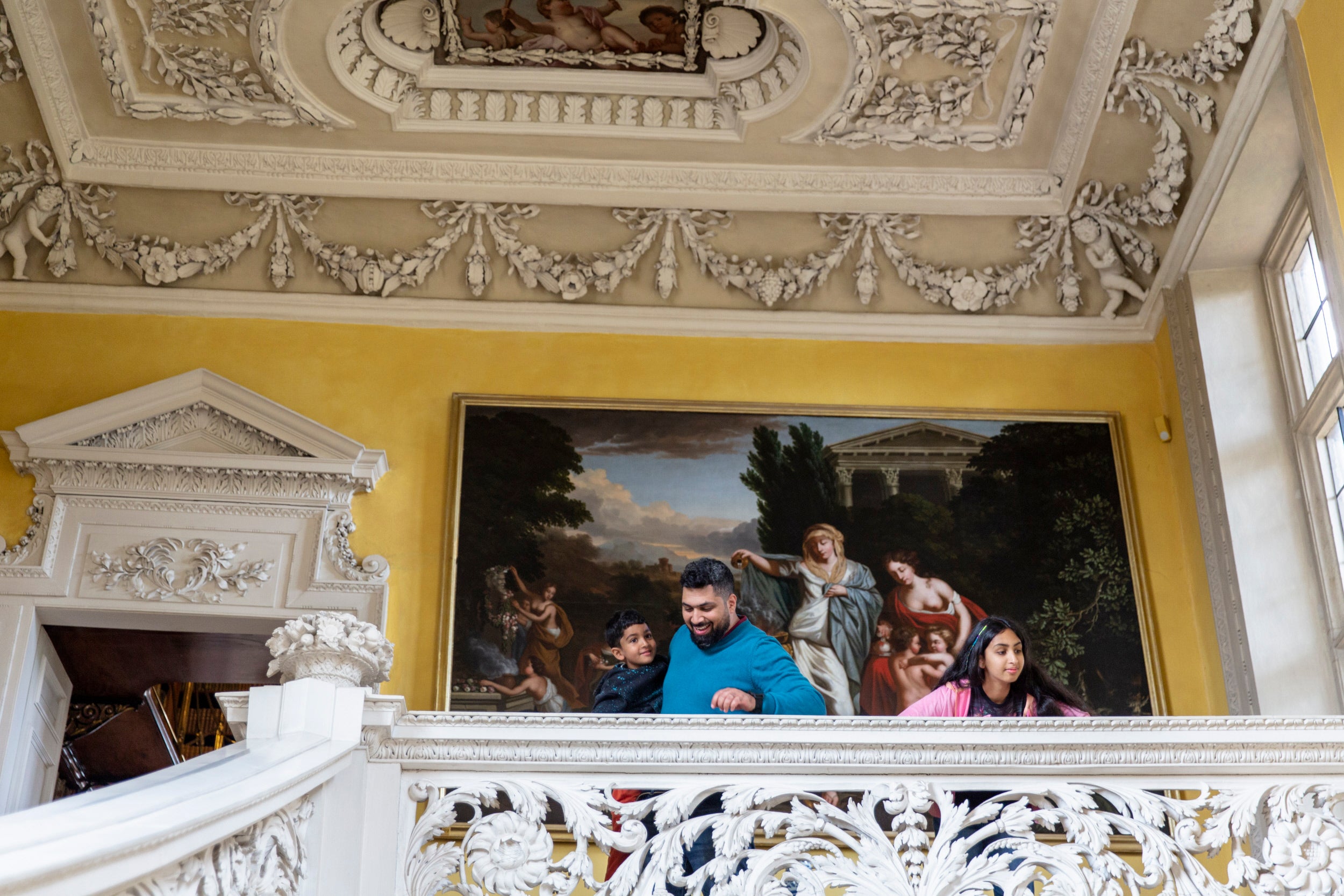 Family admiring the Great Stairs at Sudbury Hall