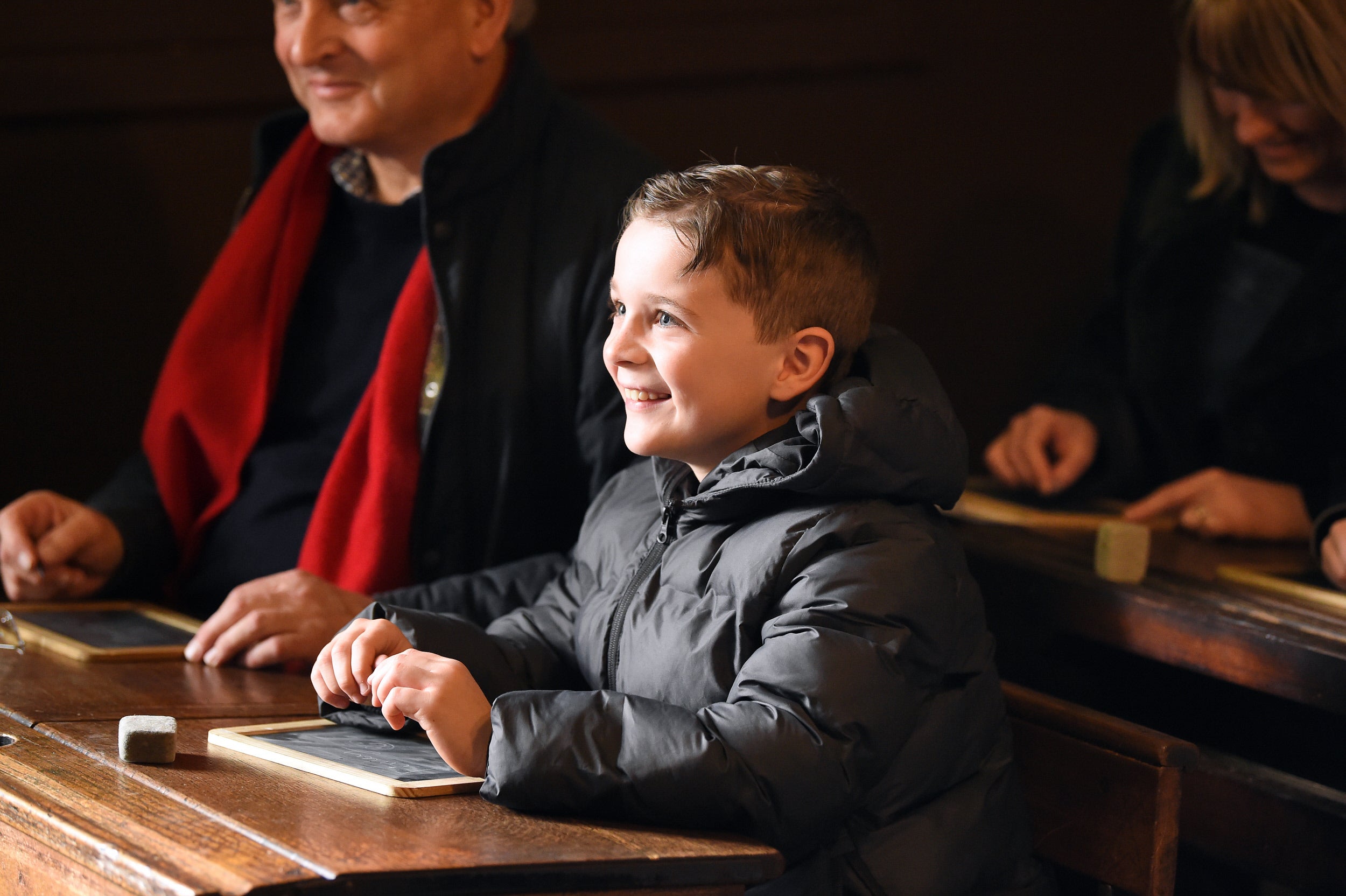 Young boy engaged in Victorian Schoolroom lesson at The Children's Country House