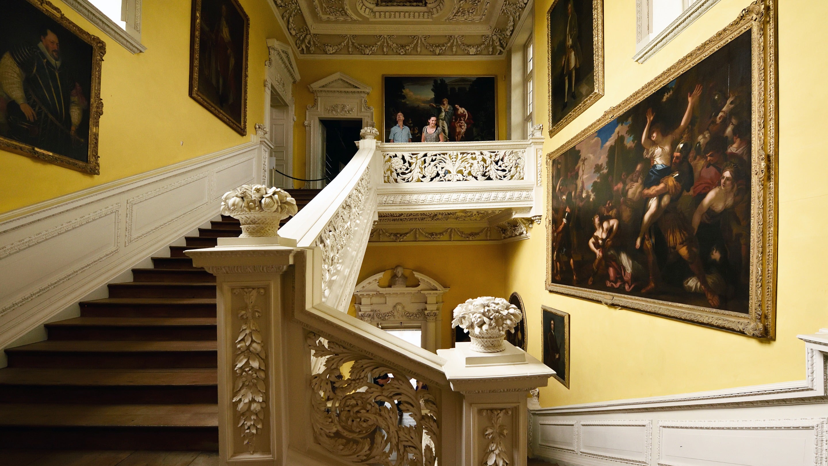 Visitors in the Staircase Hall at Sudbury Hall and the National Trust Museum of Childhood, Derbyshire