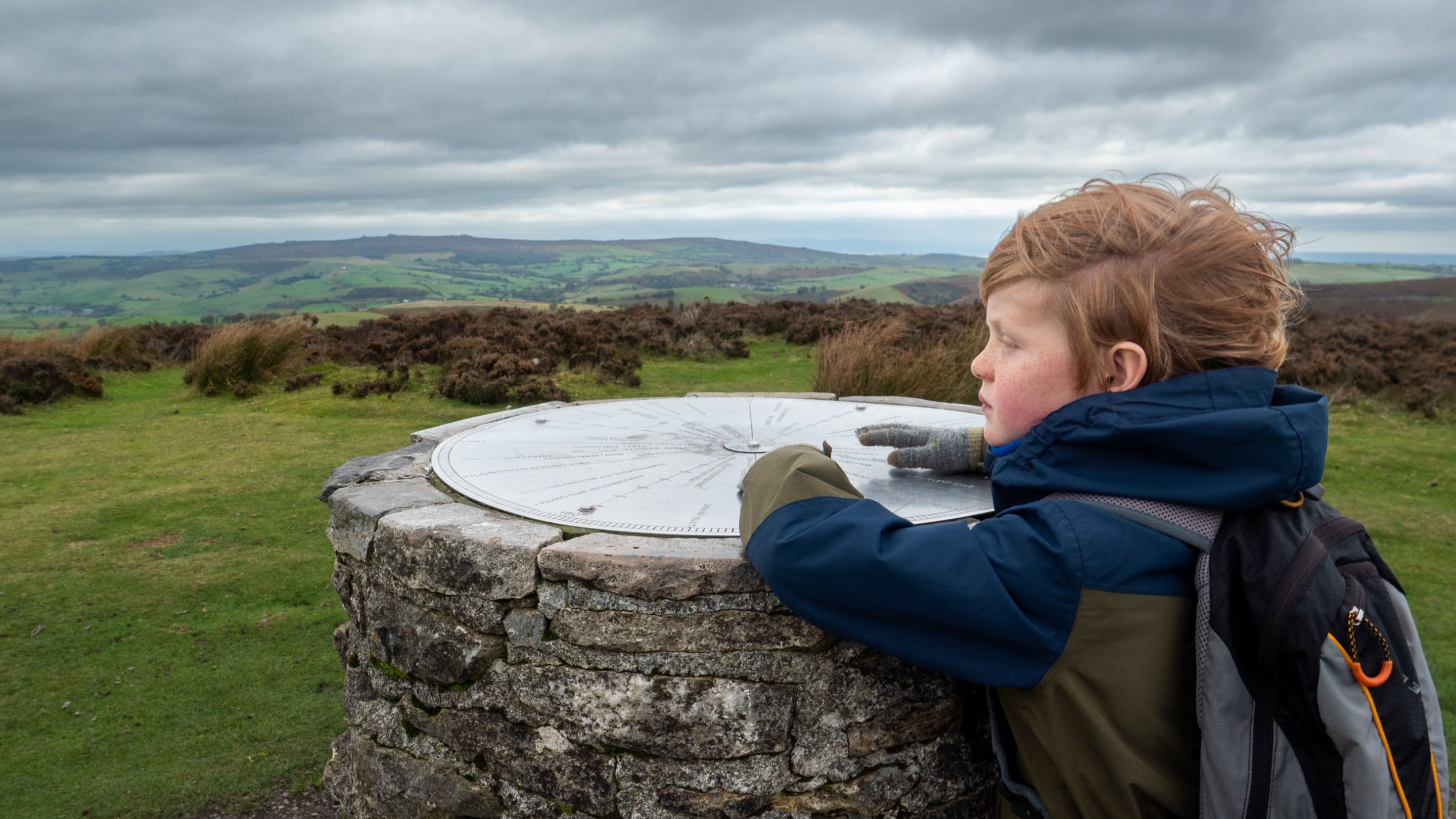 A child looks out from the top of Pole Bank at Long Mynd, Shropshire