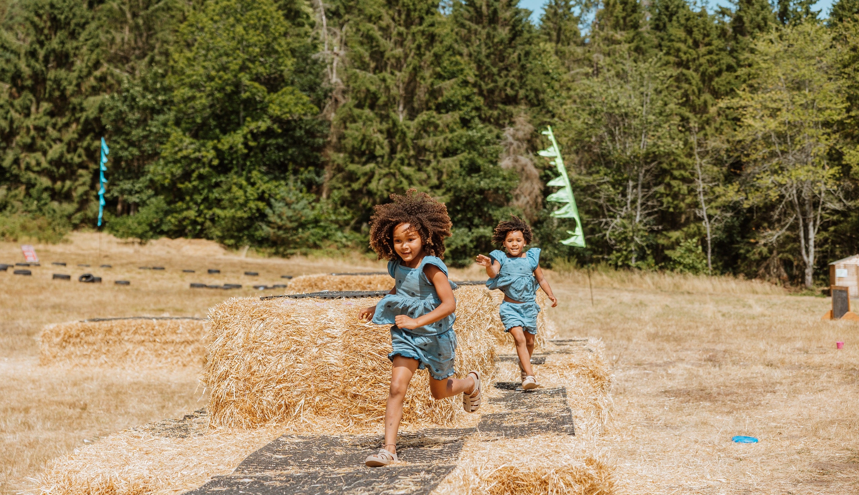 Summer of Play Comer Woods Girls on Straw bales Lucy Rebecca Photography