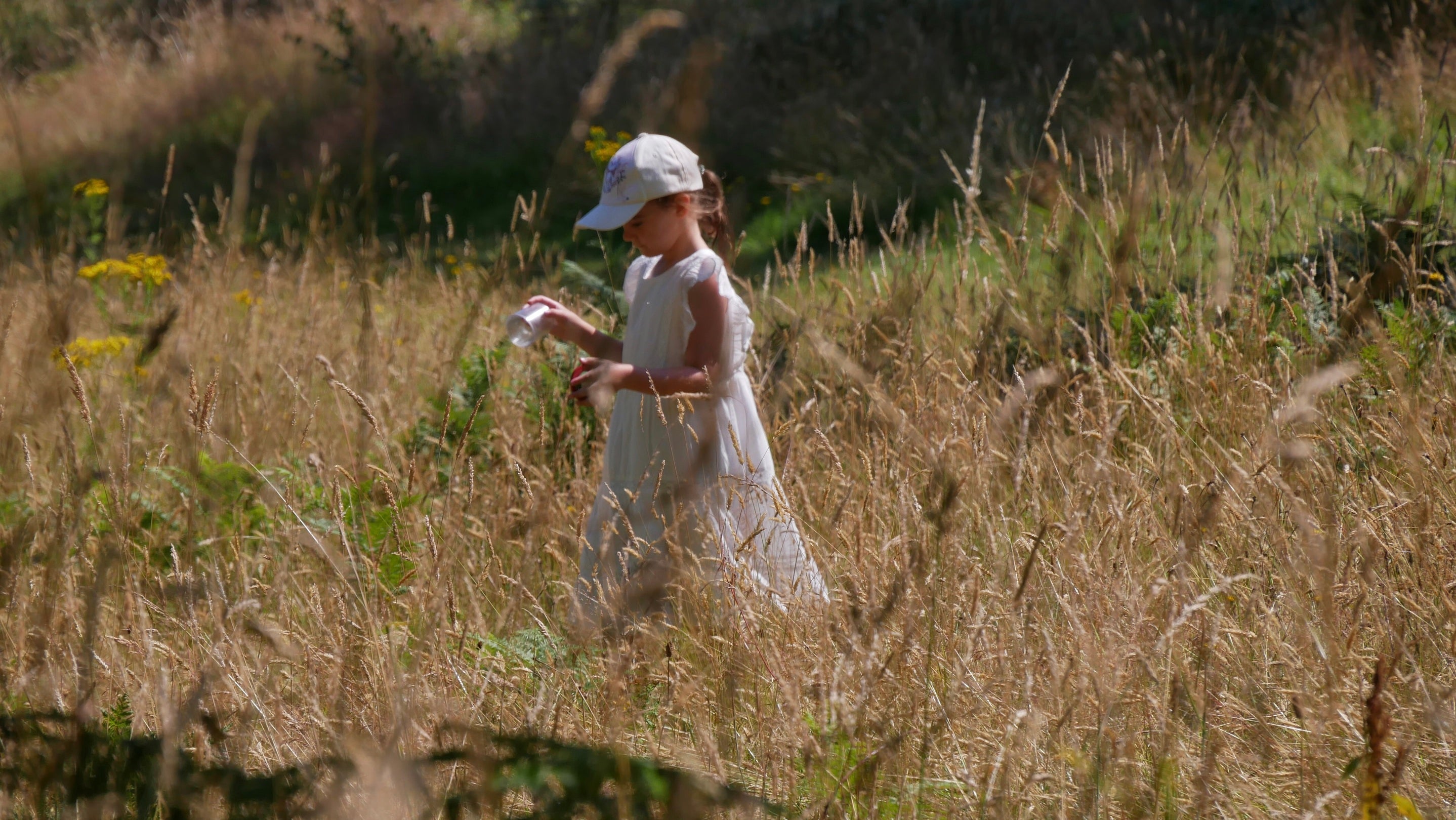 Girl in white dress in long grass