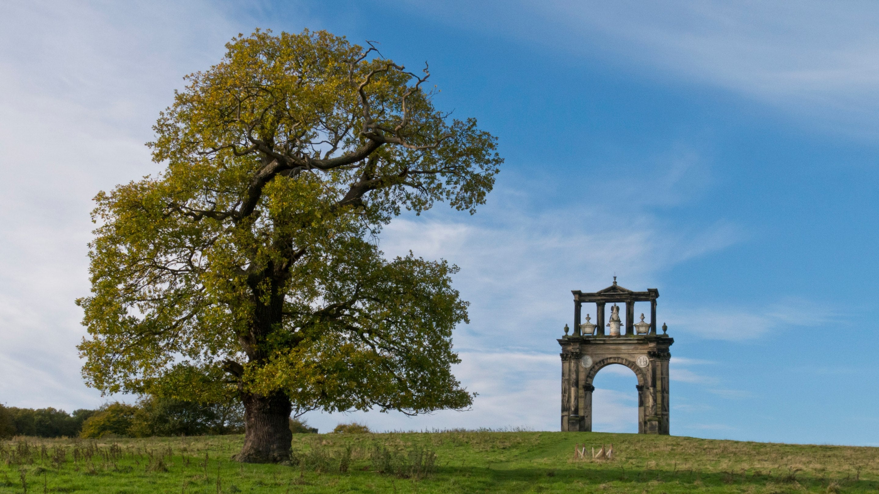 Triumphal Arch at Shugborough Estate, Staffordshire with a tree to the left. Constructed in 1765 and is a copy of Hadrian's Arch in Athens. It commemorates Admiral Anson.