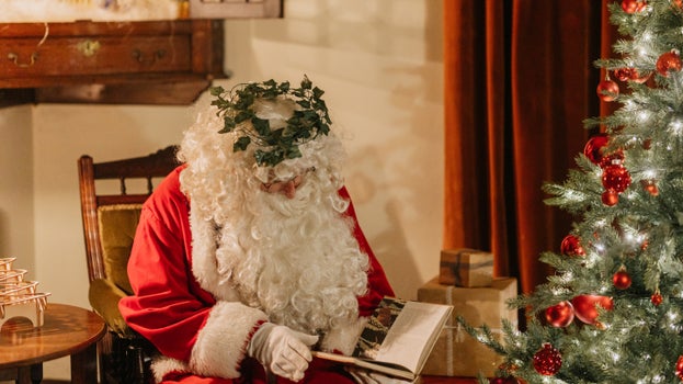 Father Christmas reading a book at Sunnycroft, Shropshire
