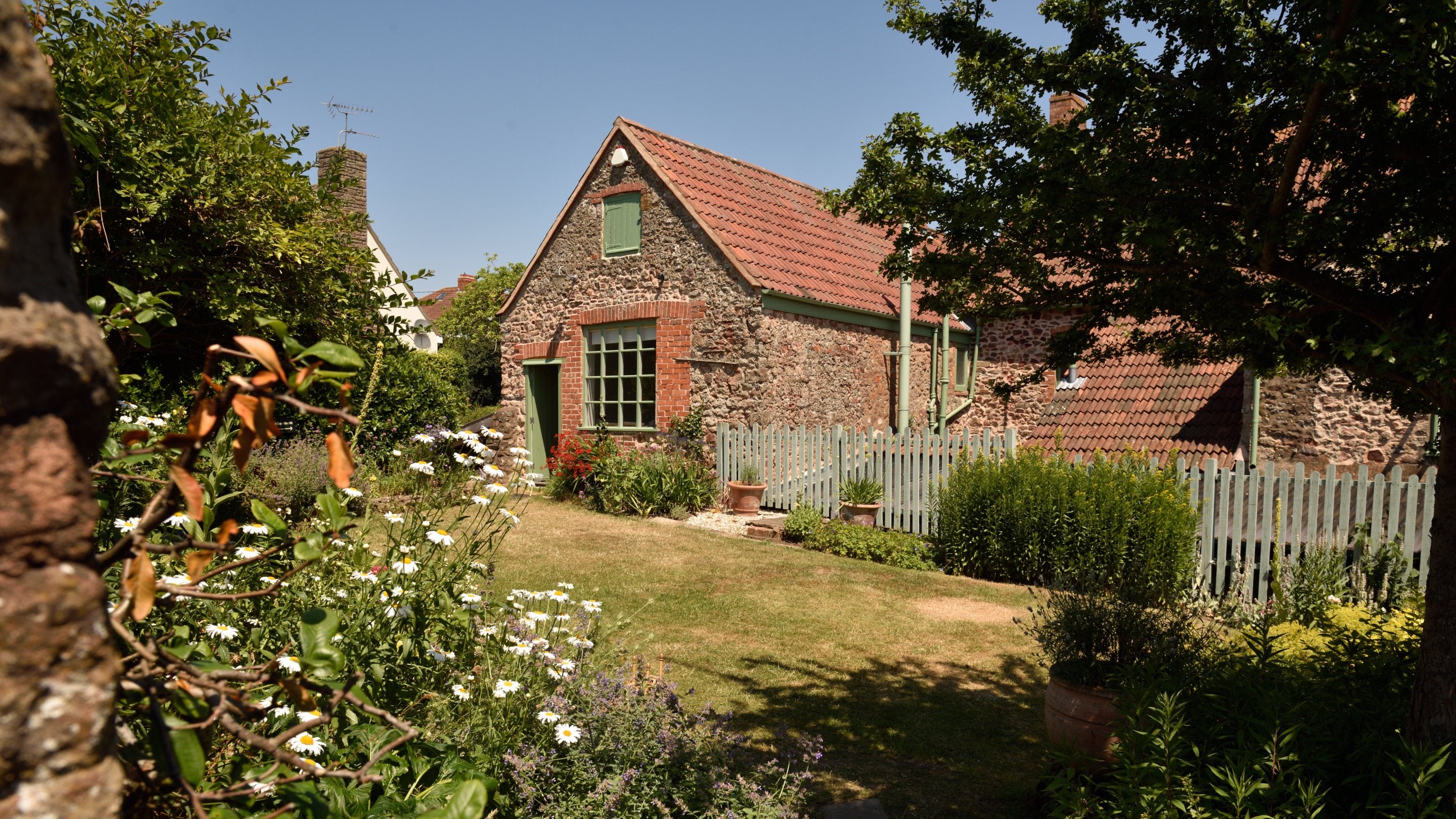 A view of the cottage and the rear garden at Coleridge Cottage, Somerset