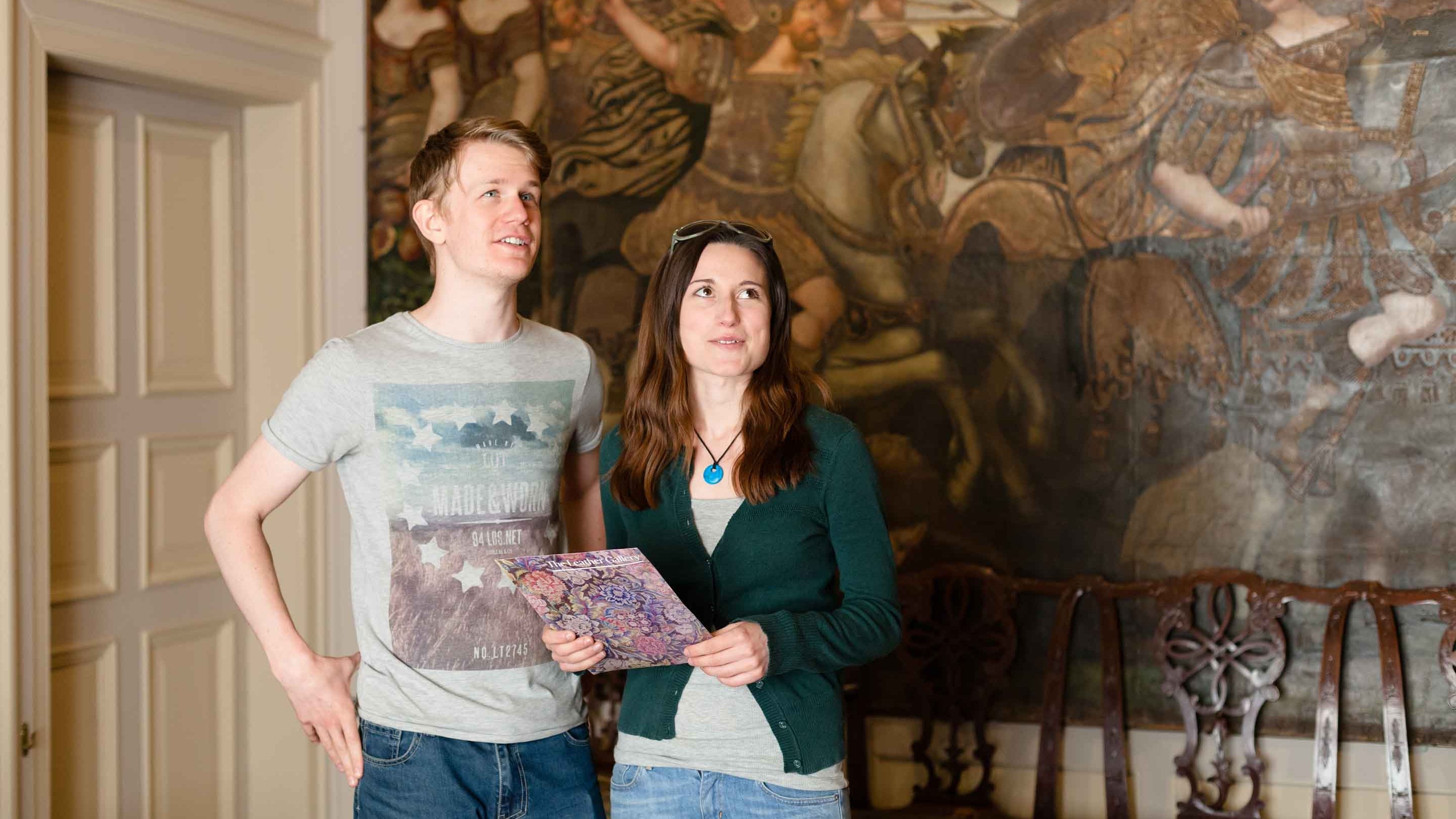 Two people visit the Leather Gallery at Dunster Castle, Somerset