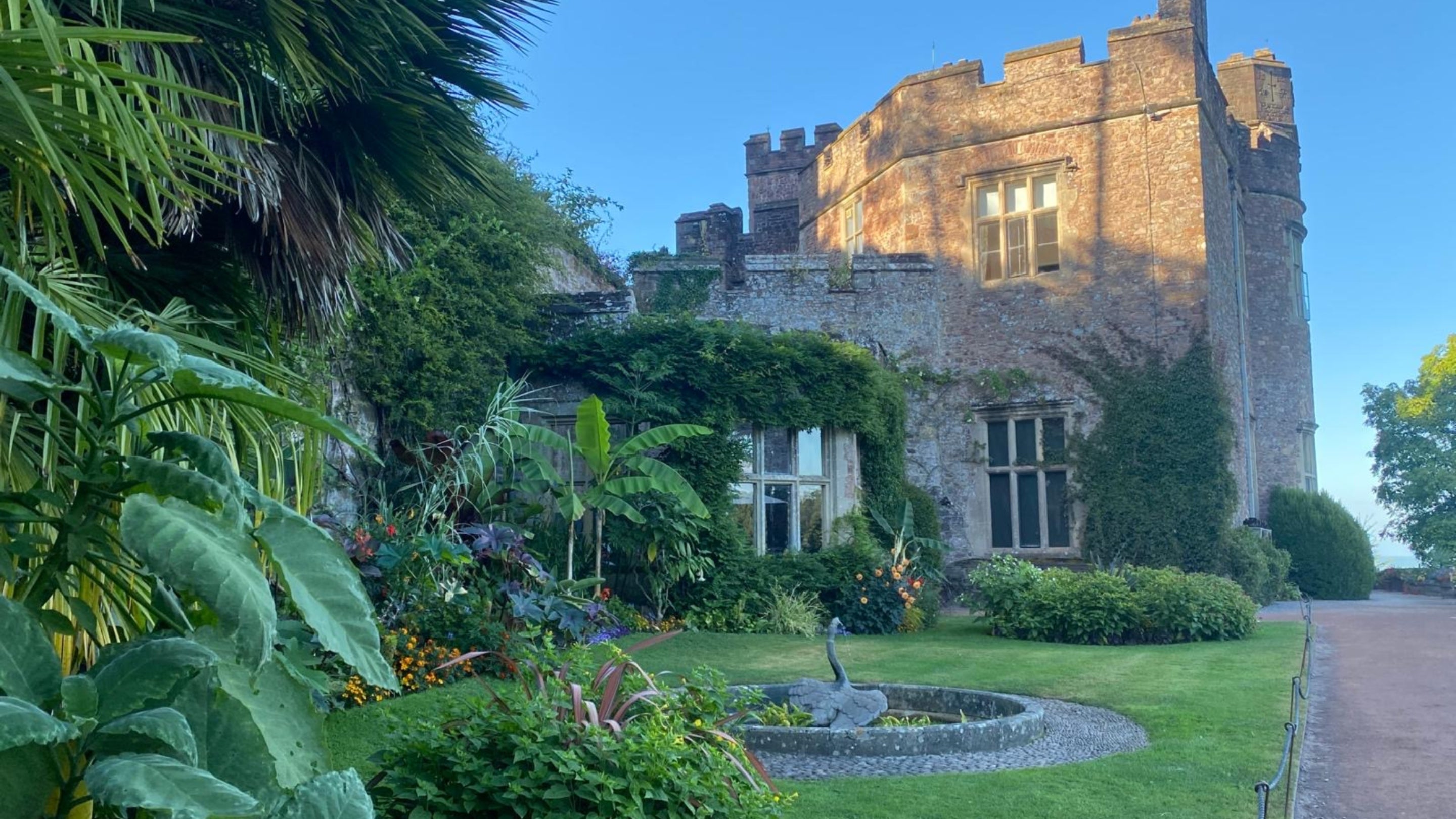 The South Terrace in the early evening light at Dunster Castle and Watermill on a summer's evening with blue skies.