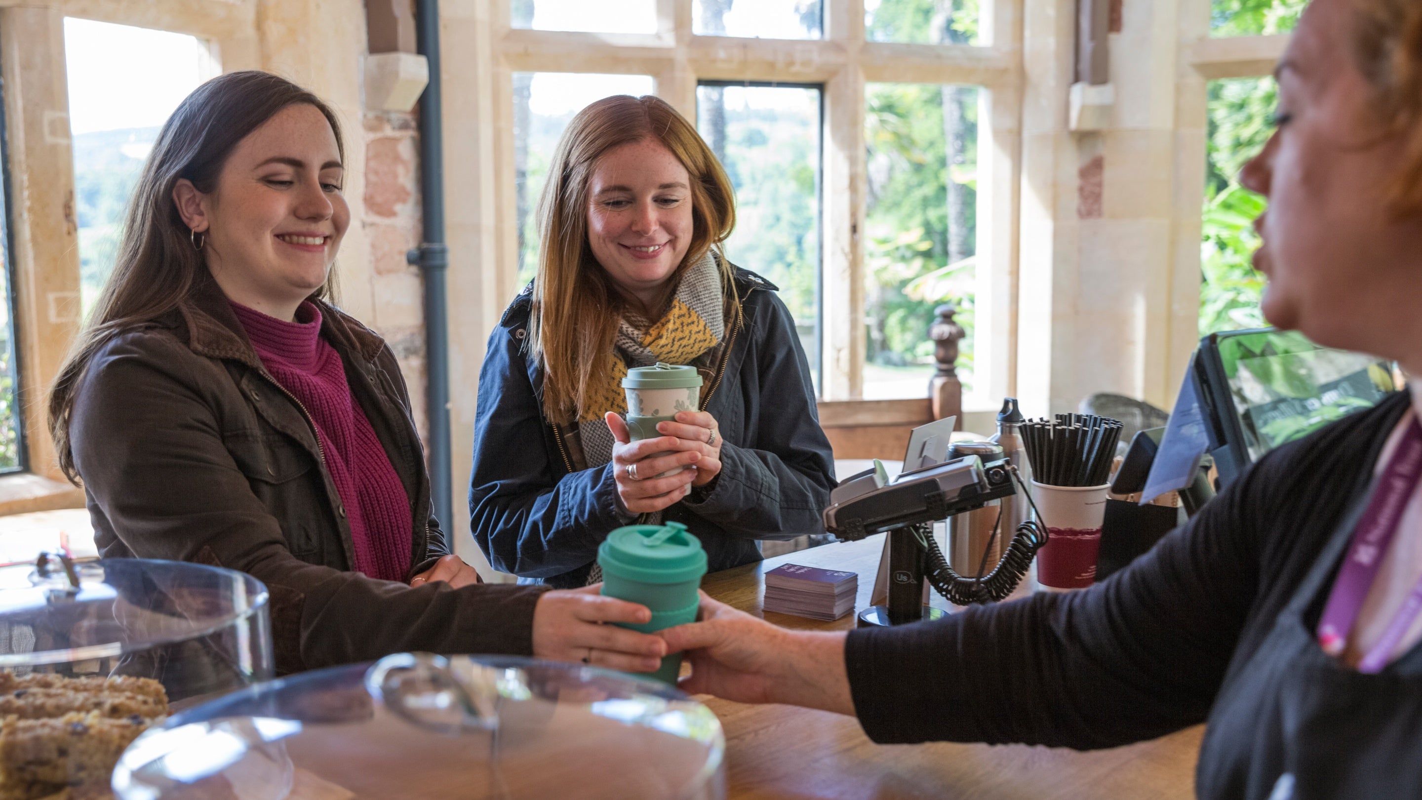 Visitors using eco cups for hot drinks at Dunster Castle, Somerset