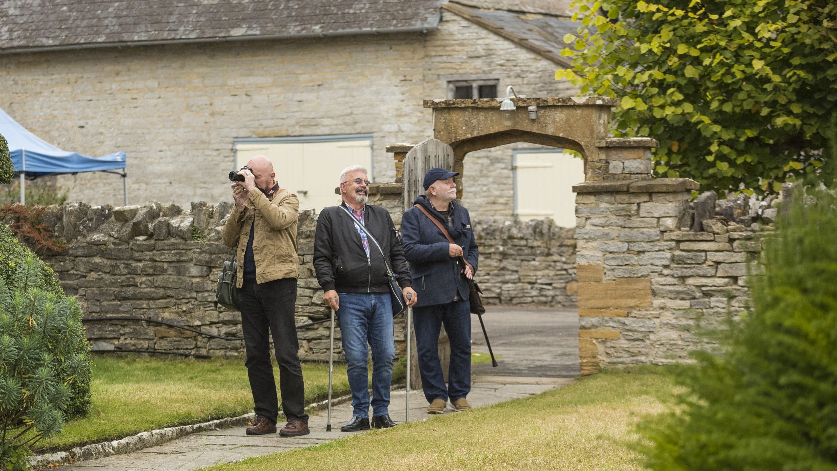 Three visitors entering the garden at Lytes Cary Manor
