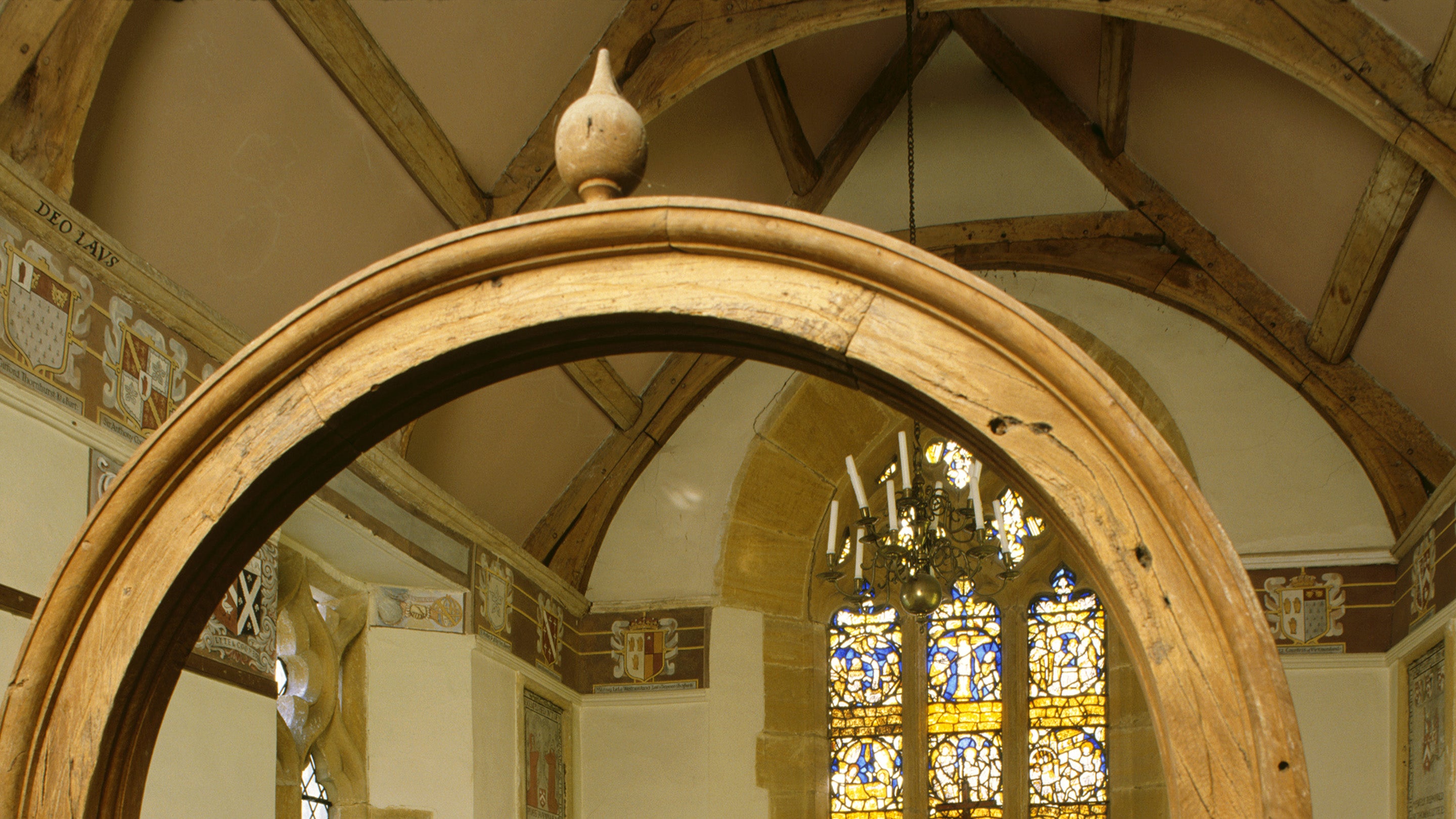 View of chapel with roof renovated by Thomas Lyte 1631, frieze of family's coat of arms, stained glass windows installed 1912 by Sir Walter Jenner.