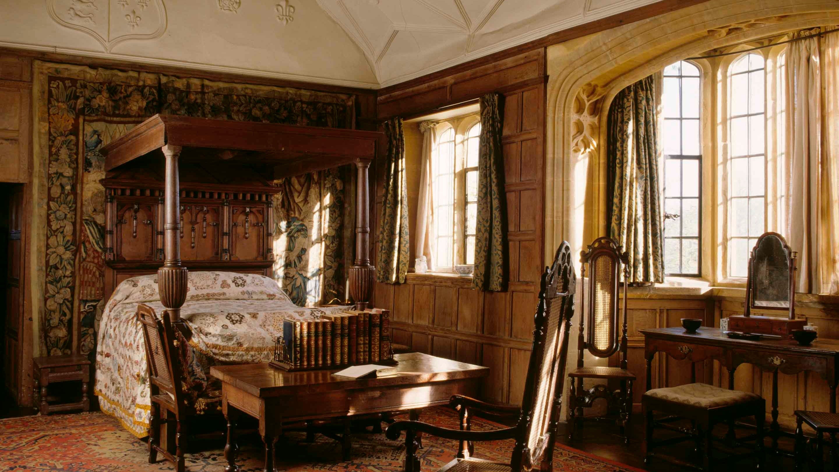 View of Great Chamber with large oak bed with panelled tester and large curved windows