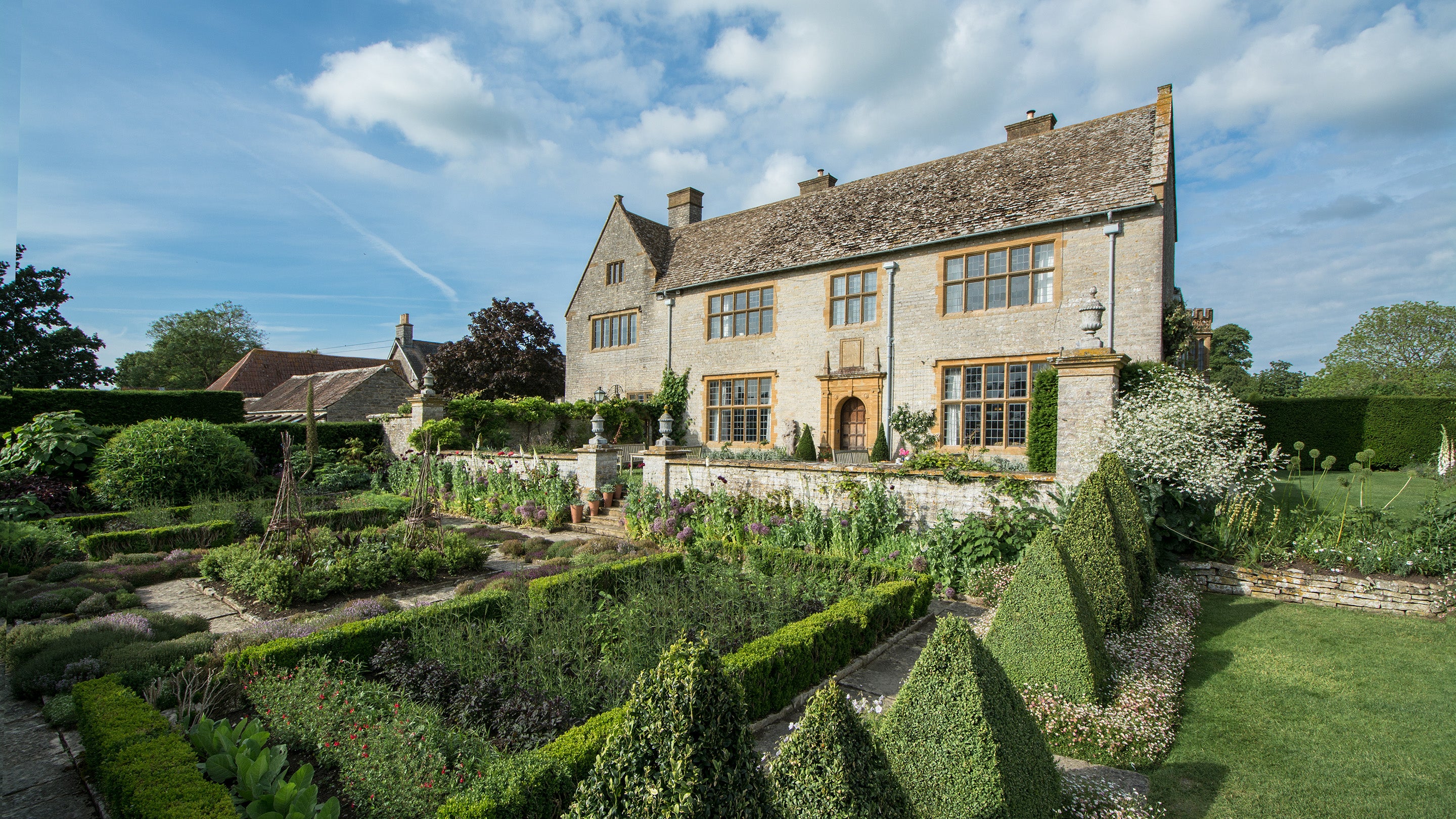 The exterior of Lytes Cary Manor, Somerset, showing parts of the gardens