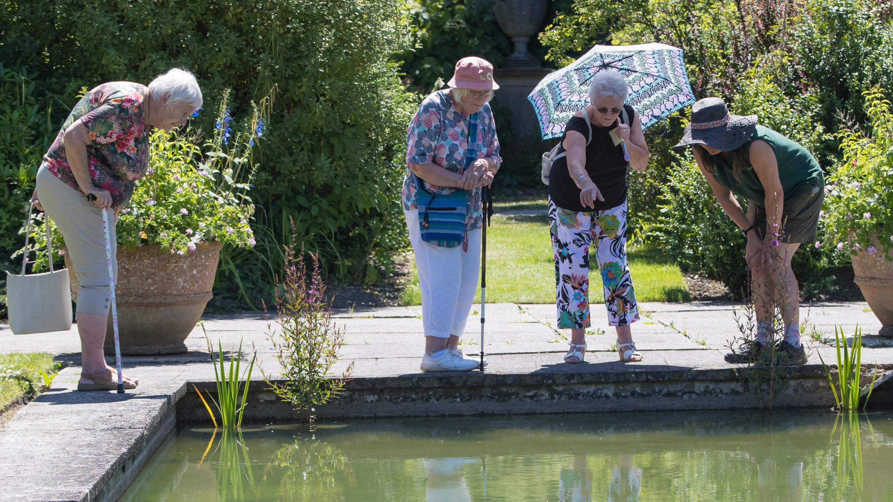 Visitors in the Pool Garden at Tintinhull Garden, Somerset