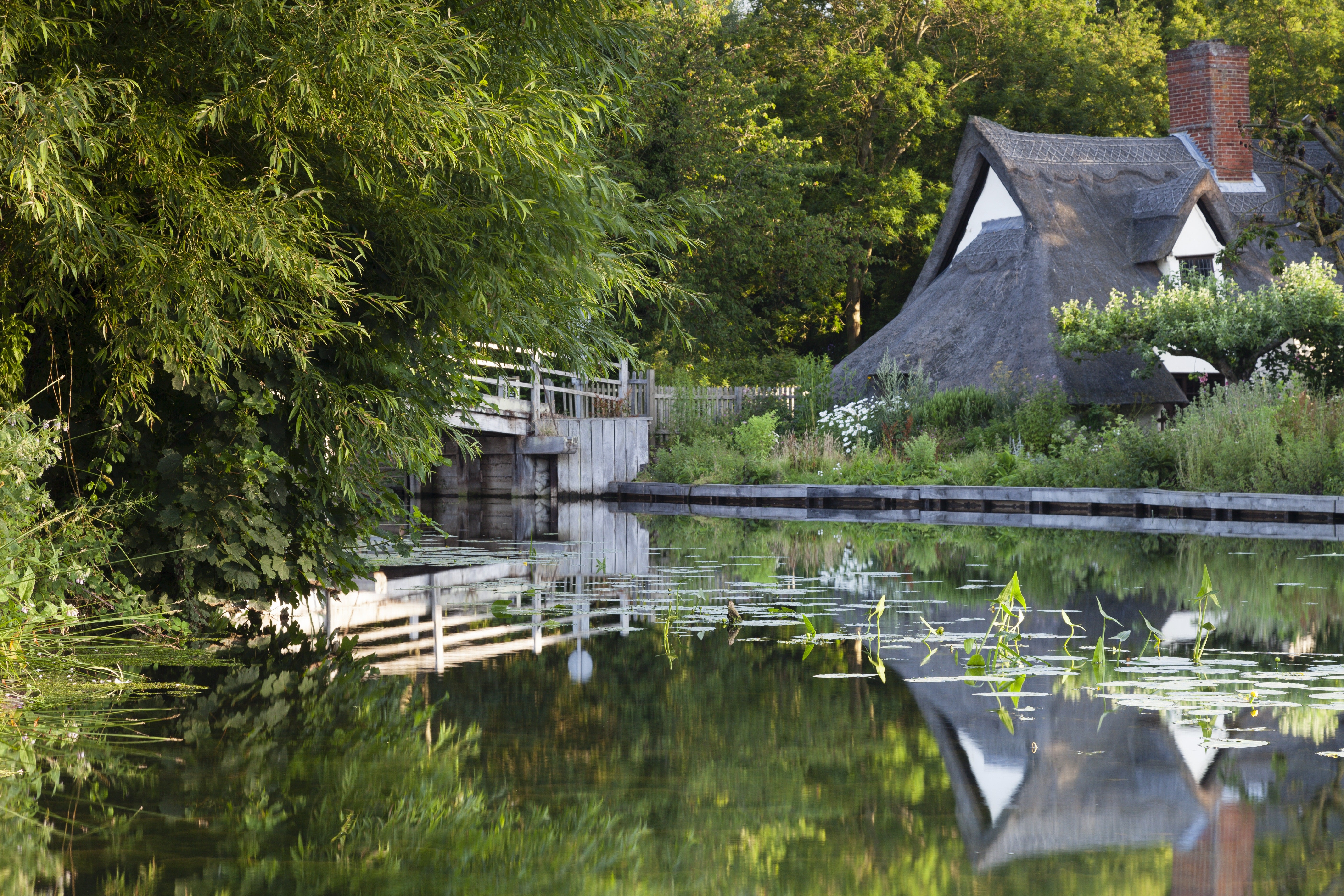 Bridge Cottage reflected in the water at Flatford