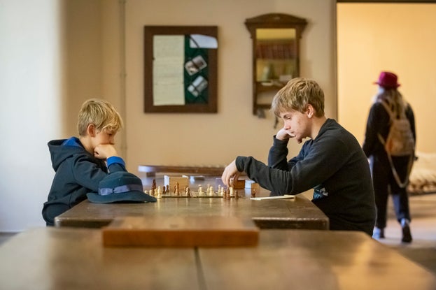 Two boys playing chess in the basement at Ickworth