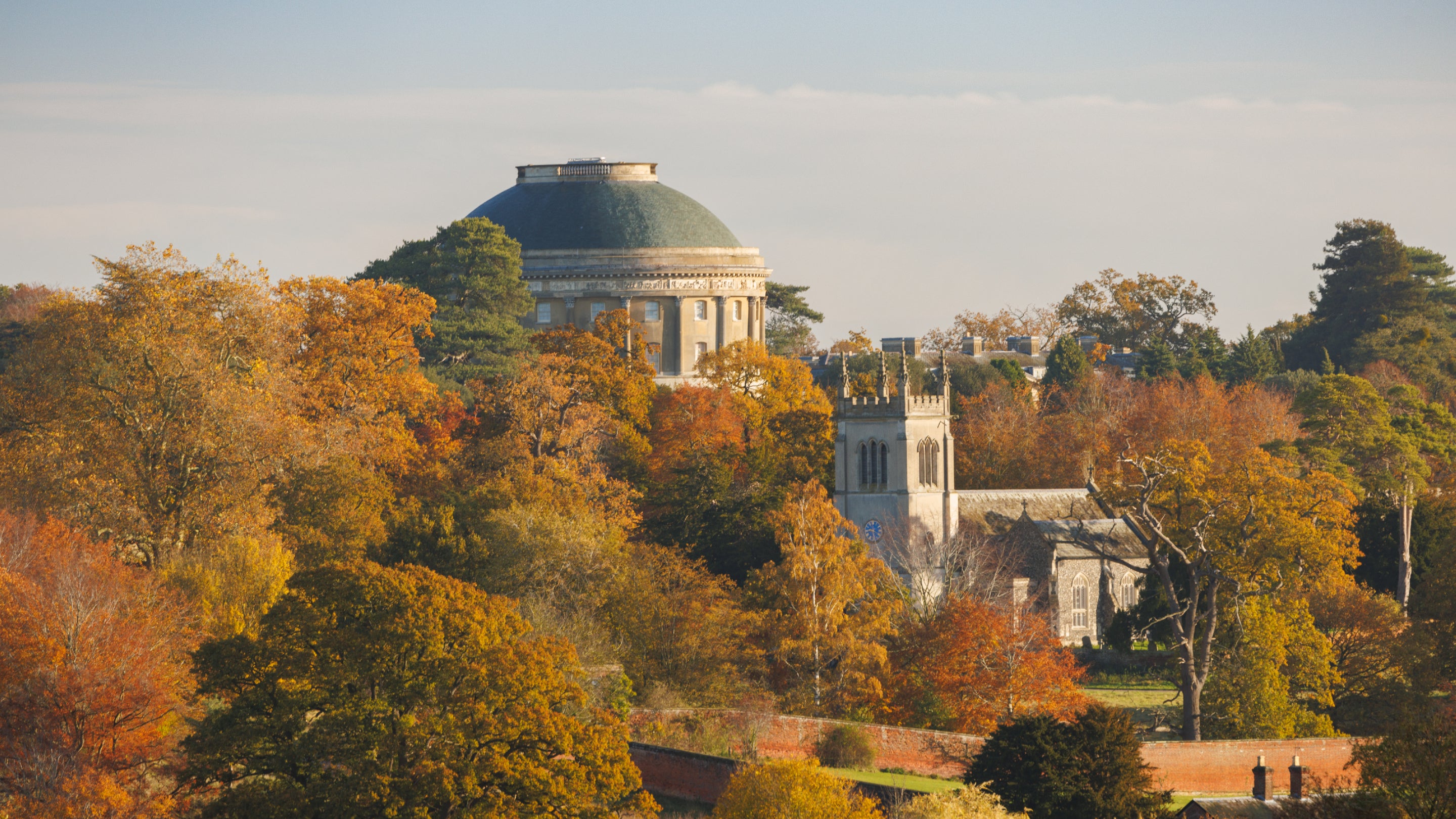 Trees in full autumn colour at Ickworth Estate surrounding the Rotunda and Church